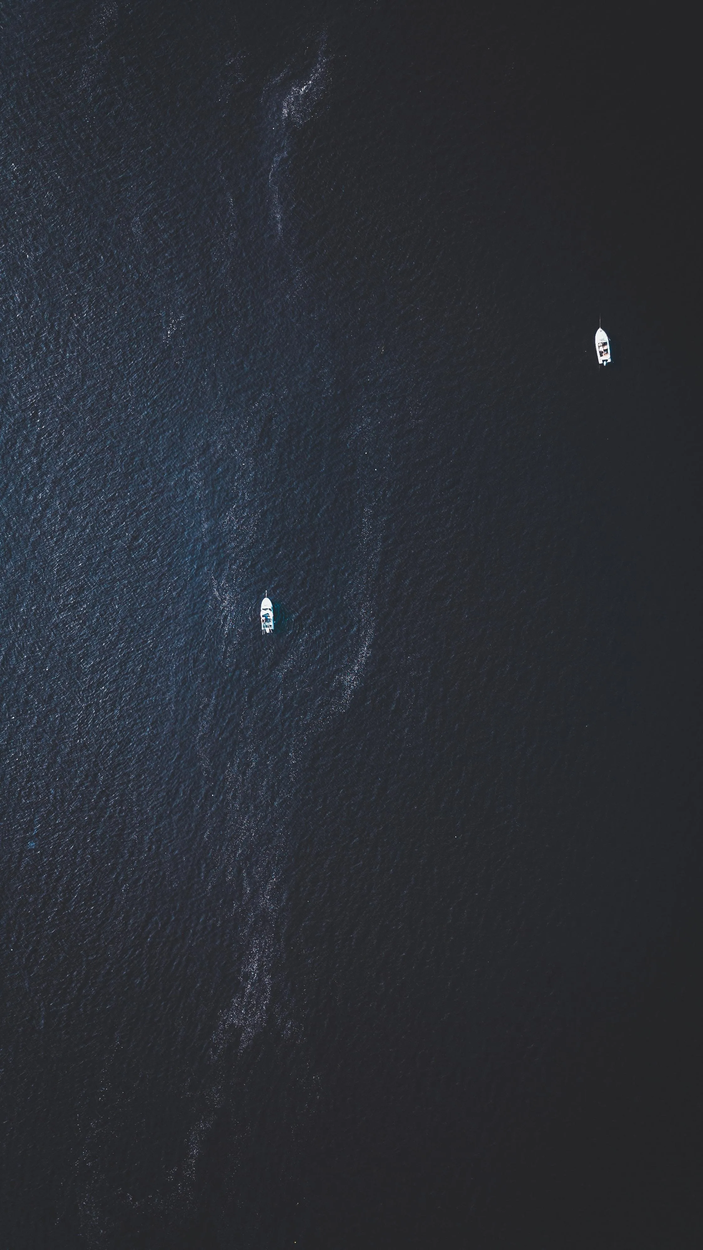 Aerial View of Boats Floating on Deep Blue Ocean Water