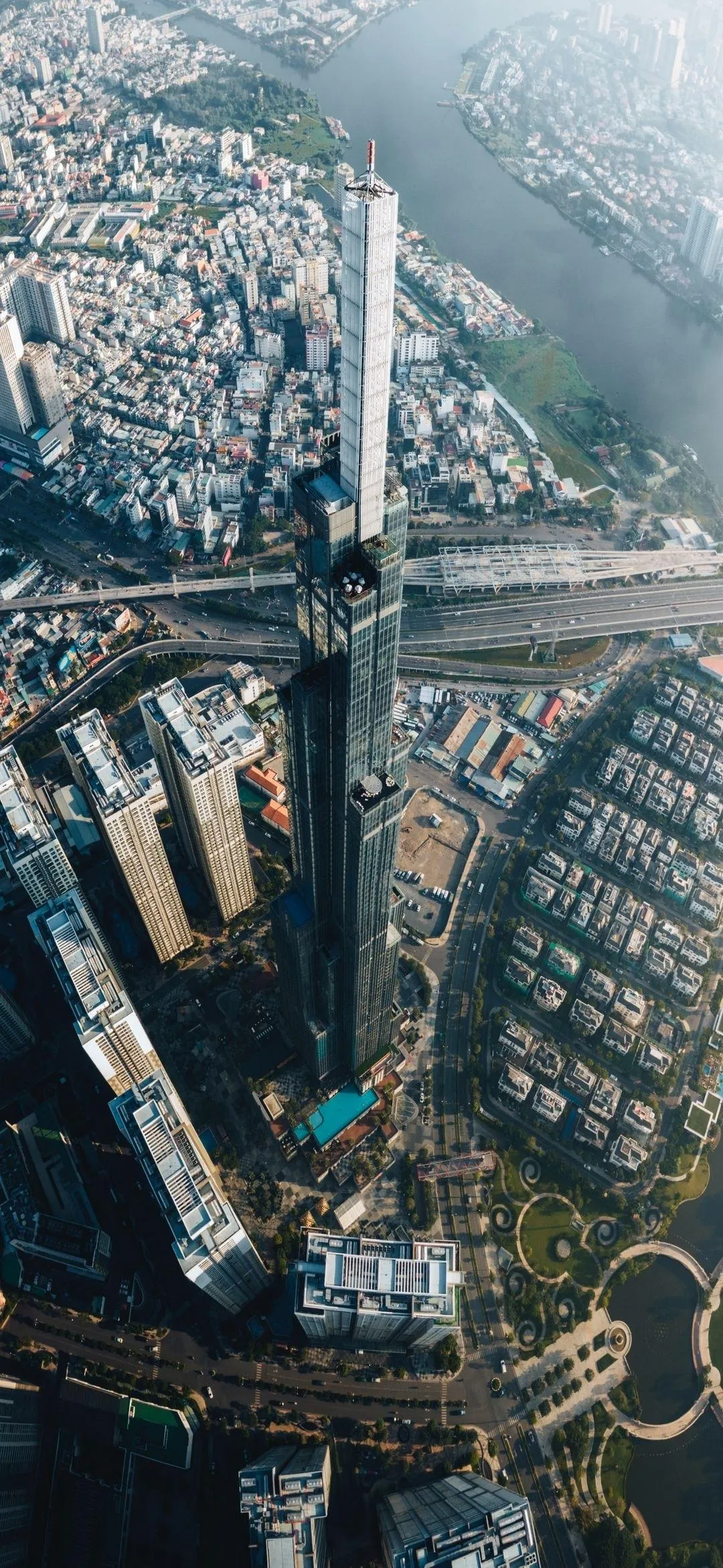 Aerial View of Bridge and Urban Cityscape Below Wallpaper