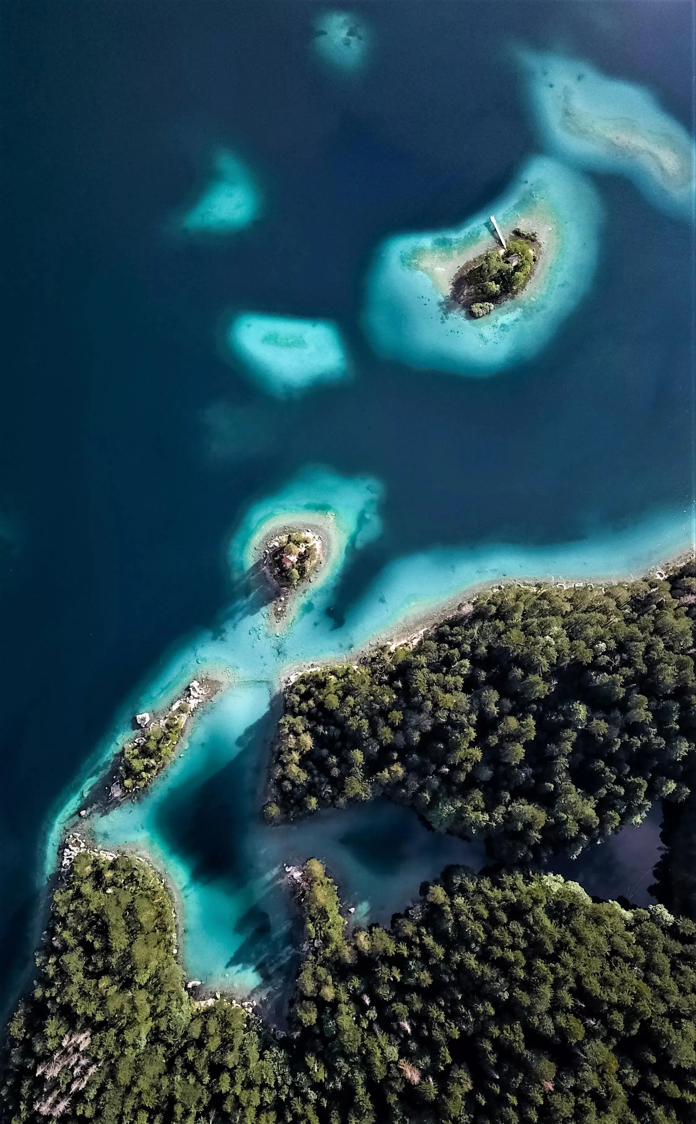 Aerial View of Bright Blue Ocean Islands and Coral Reefs