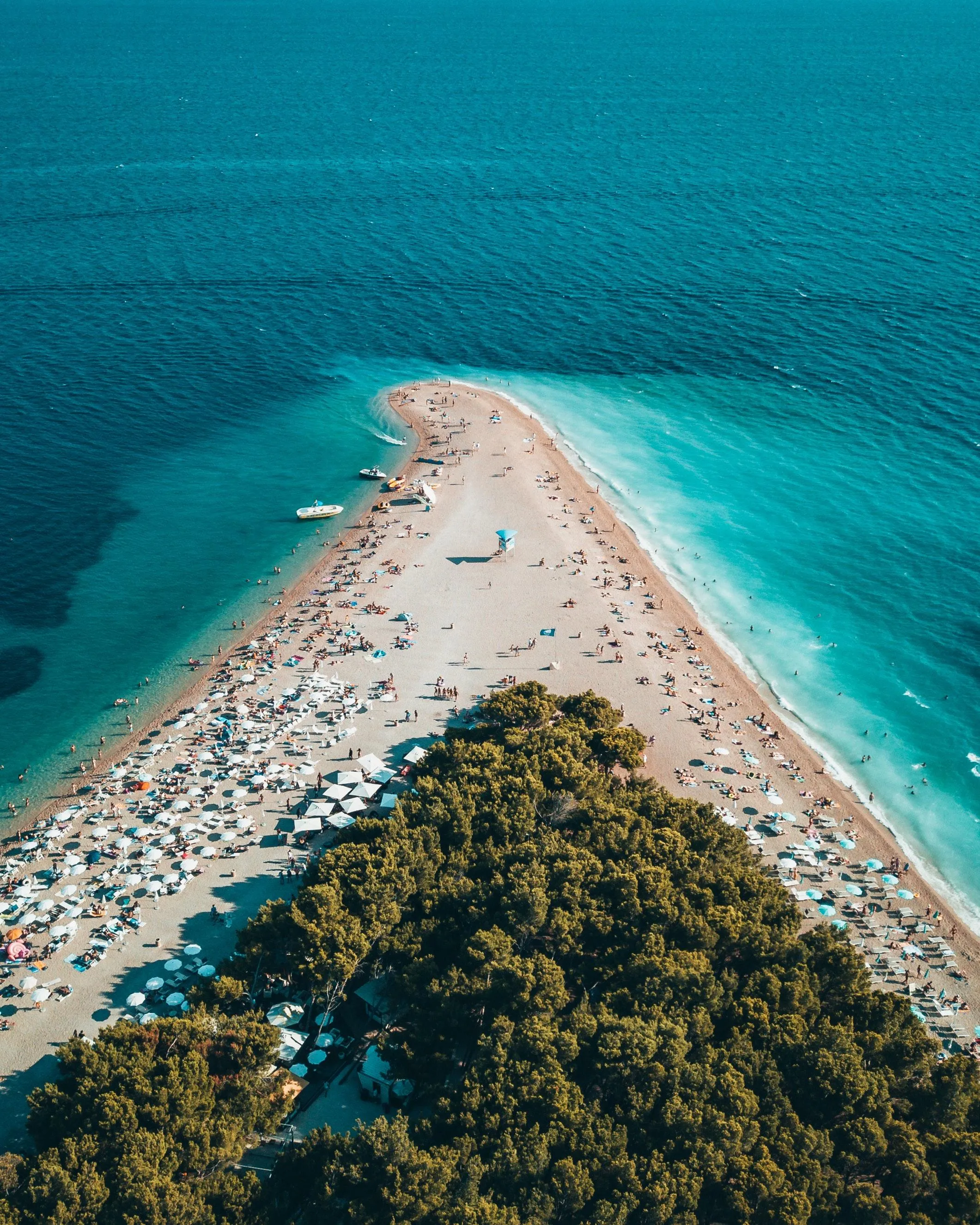 Aerial View of Bright Blue Sea Meeting Warm White Shoreline