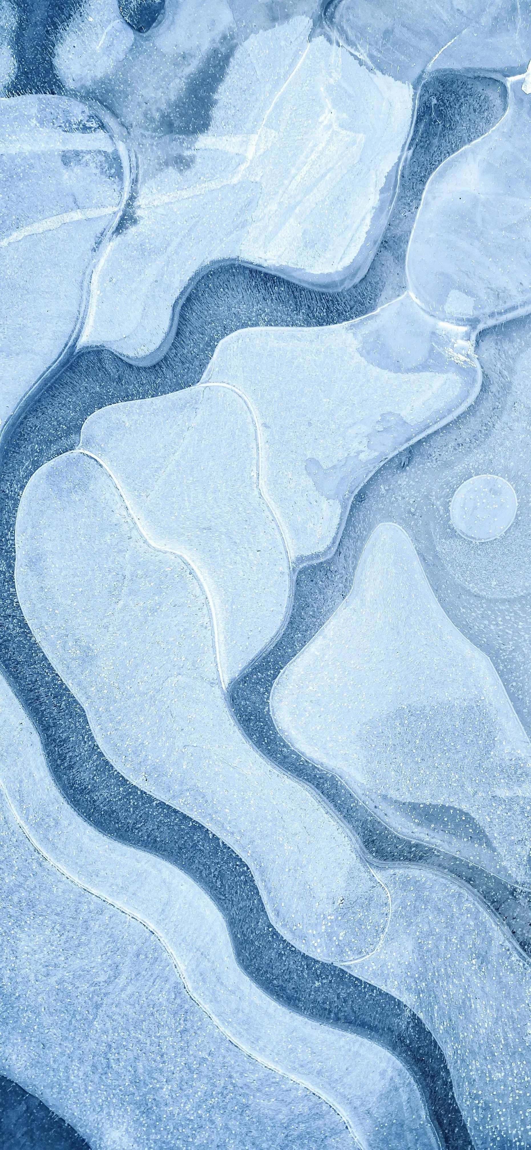 Aerial View of Ice Formations with Blue Water Path Wallpaper