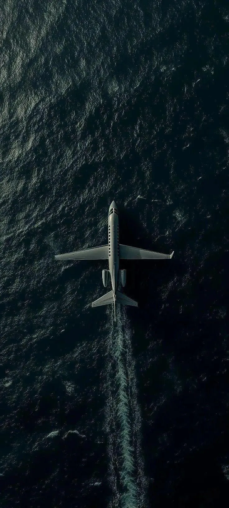 Aerial View of Jet Flying Over Deep Blue Ocean Surface