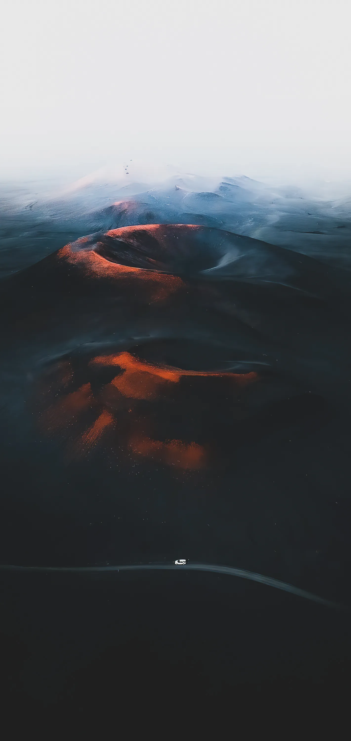Aerial View of Mountain Landscape Under a Cloudy Sky