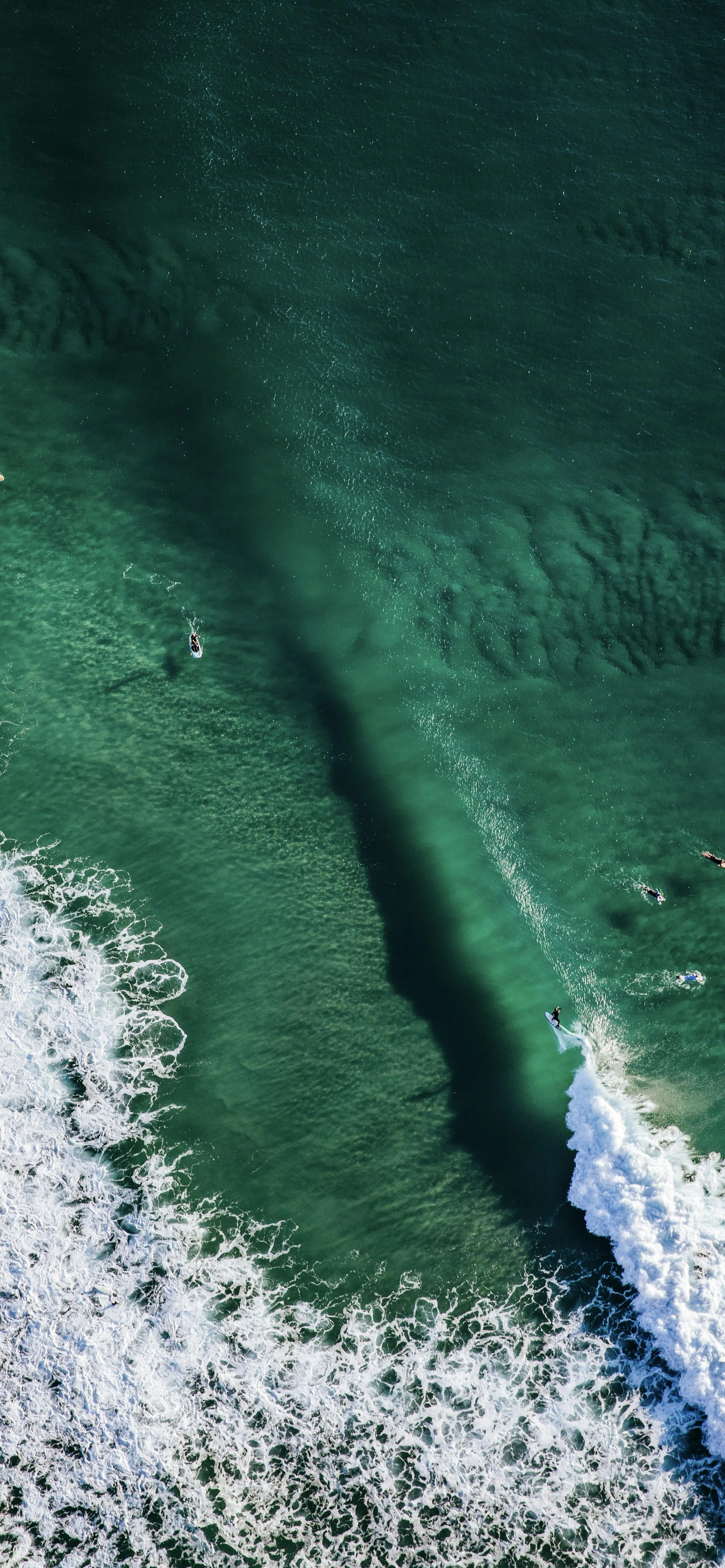Aerial View of Ocean Wave Hitting The Shore in Green