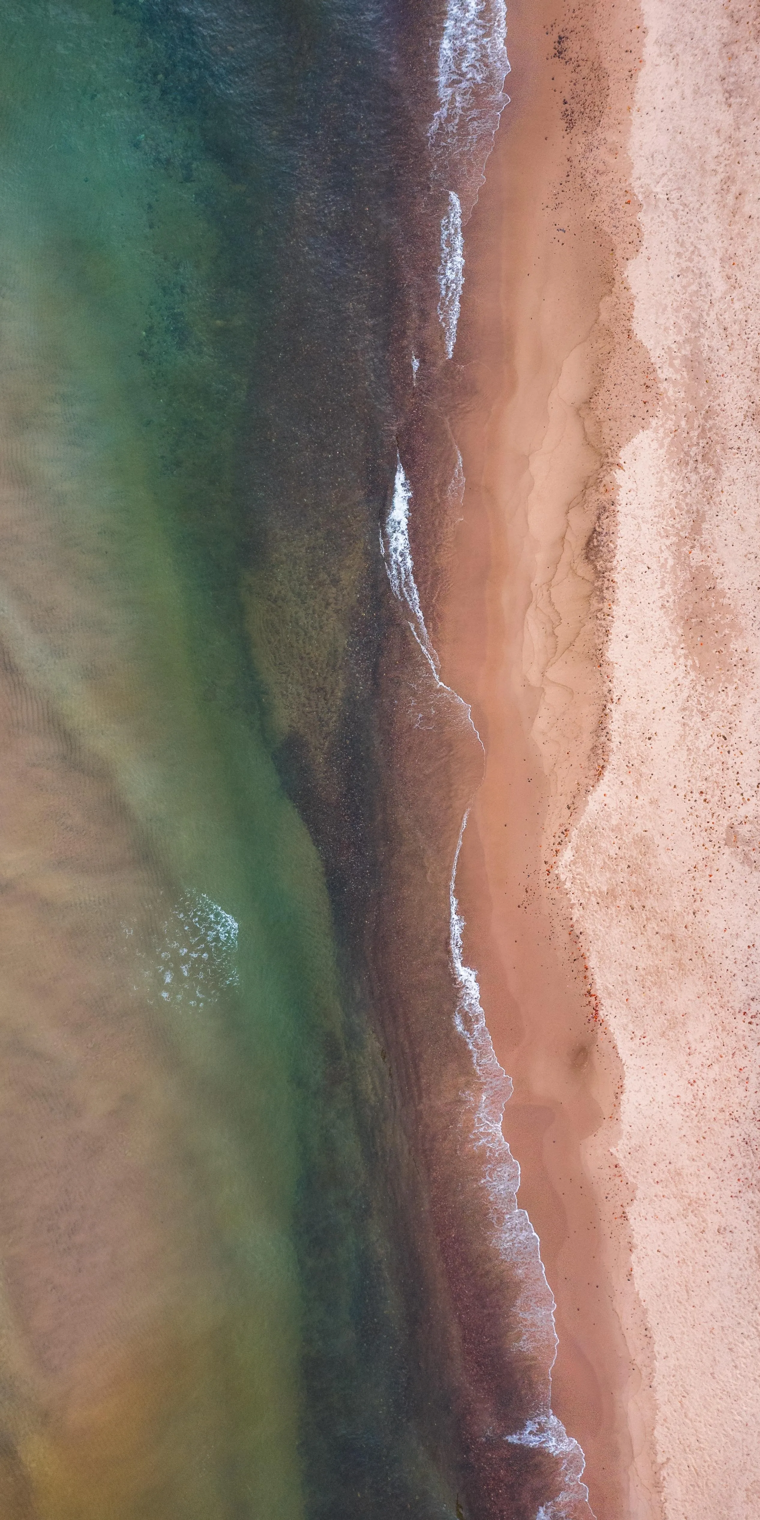 Aerial View of Sandy Beach and Ocean Waves Meeting Shore