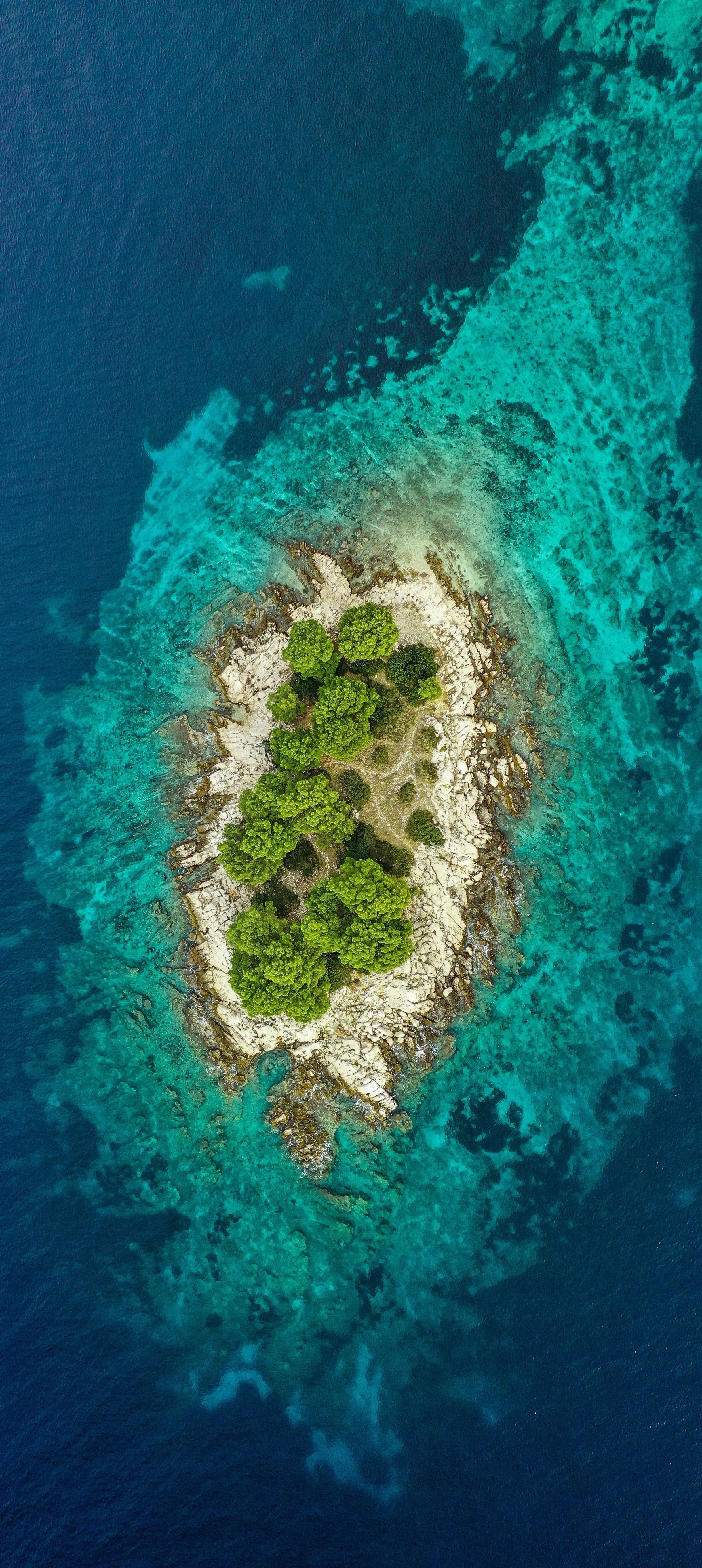 Aerial View of Tropical Island Surrounded by Ocean Wallpaper