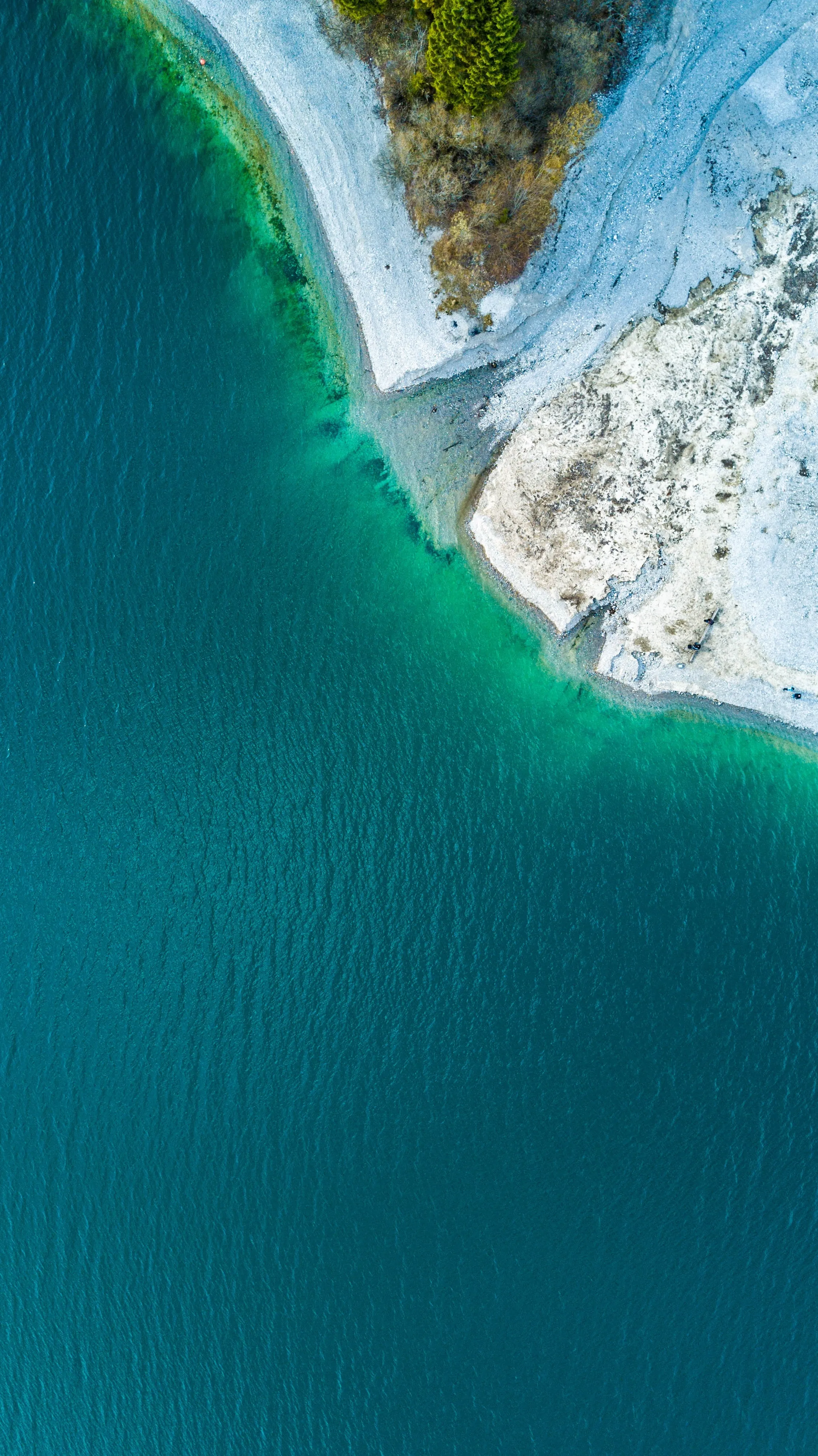 Aerial View of Turquoise Sea and Rocky Shoreline Image HD