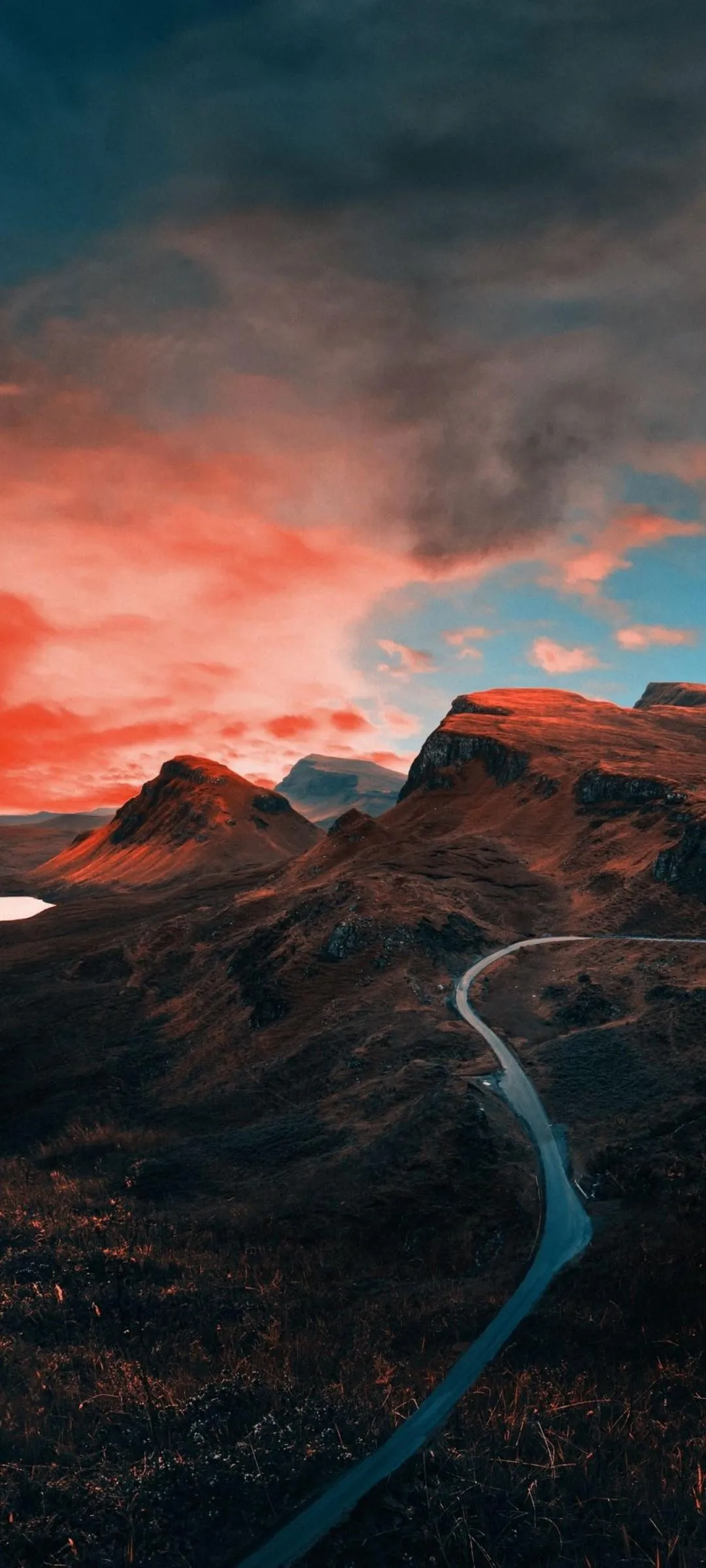 Aerial View of Winding Road Through Mountain at Sunset