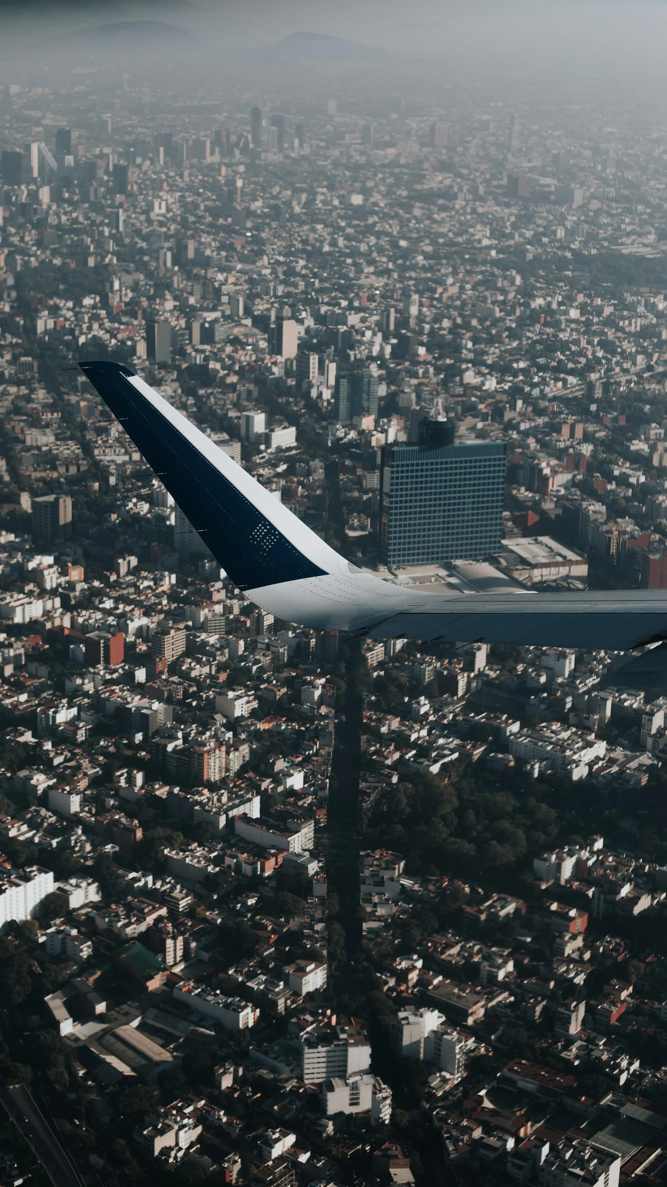 Aerial Wing View Flying Above Dense Urban Landscape