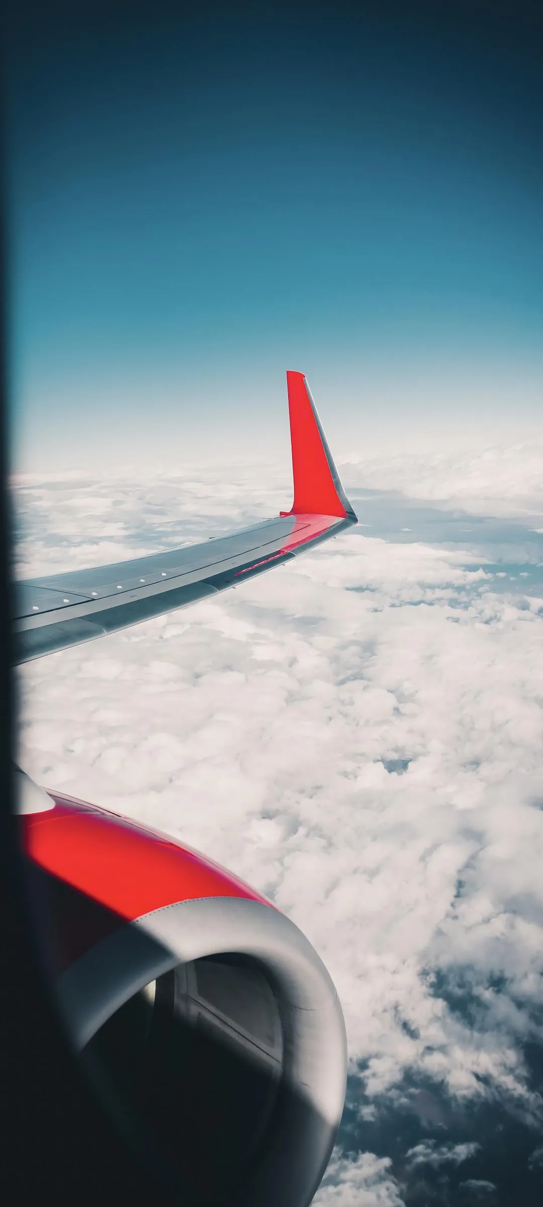Airplane Wing View Above Cloudy Blue Sky Wallpaper