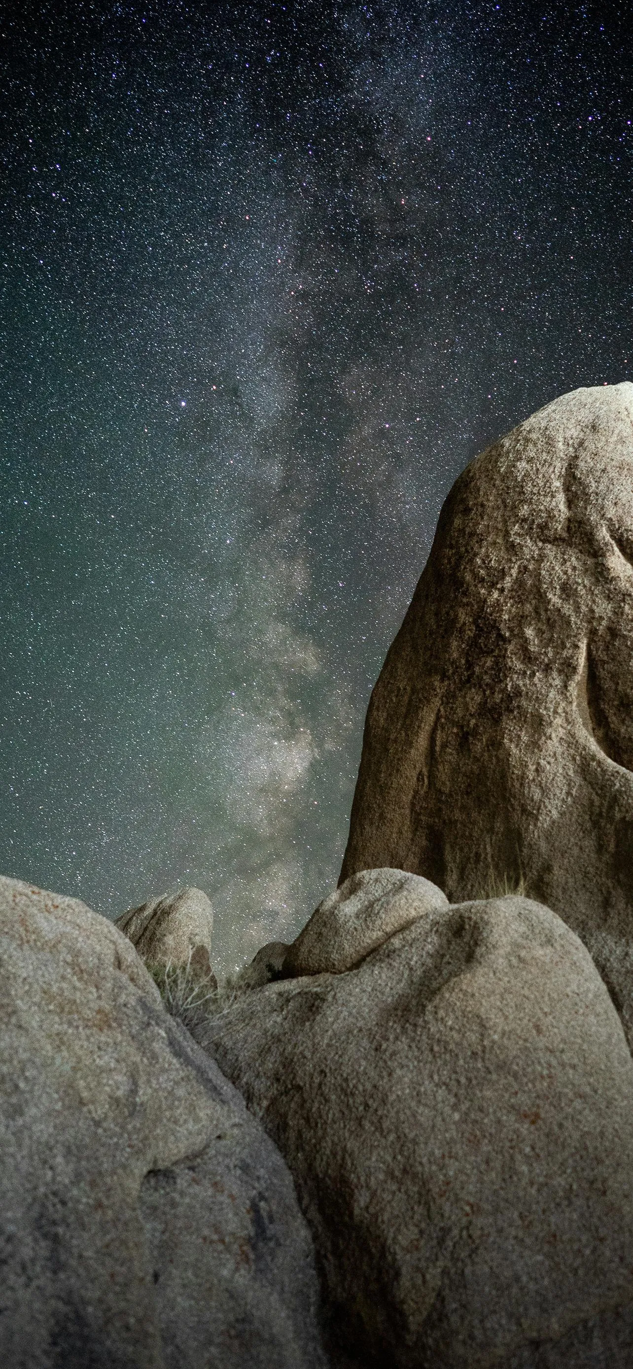 Ancient Stone Guardians Under Dramatic Sky Light Wallpaper