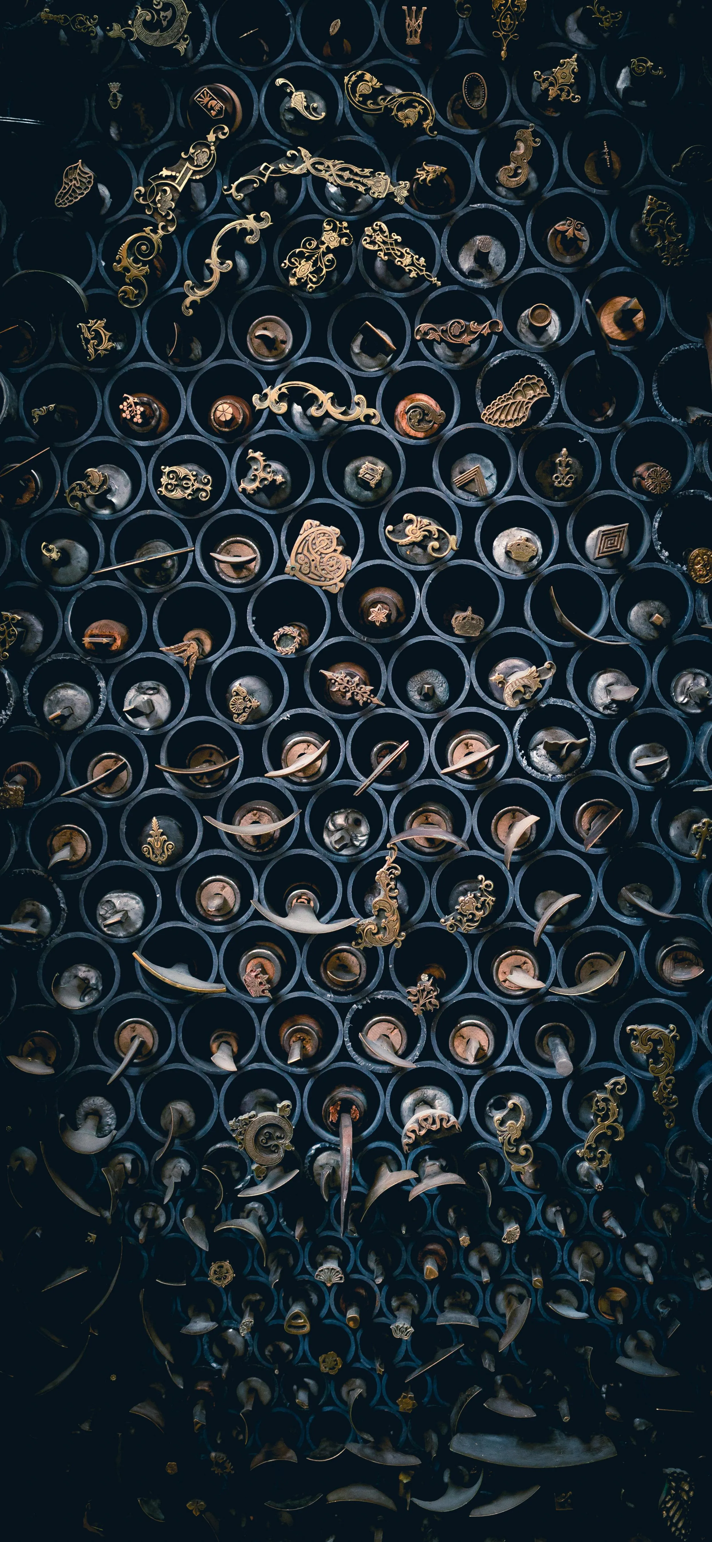 Antique Brass Handles Displayed in Organized Vertical Racks