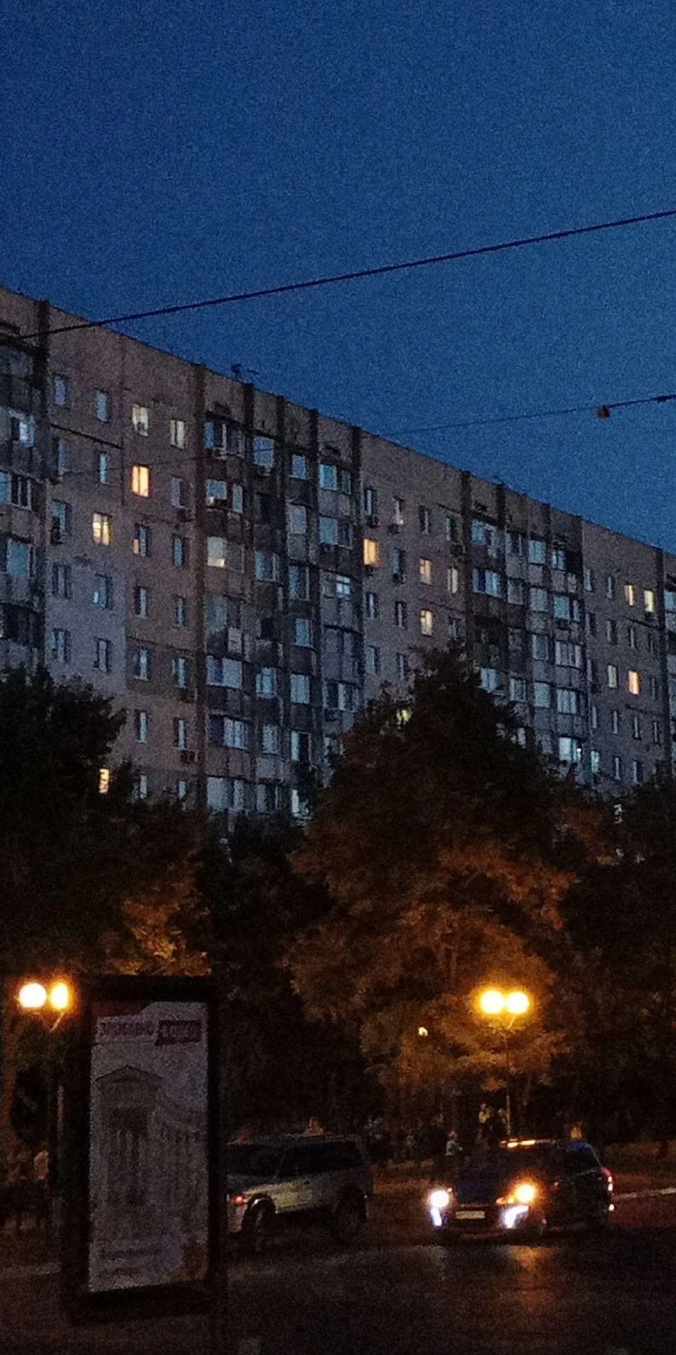 Apartment Building Windows Glowing At Blue Evening Time