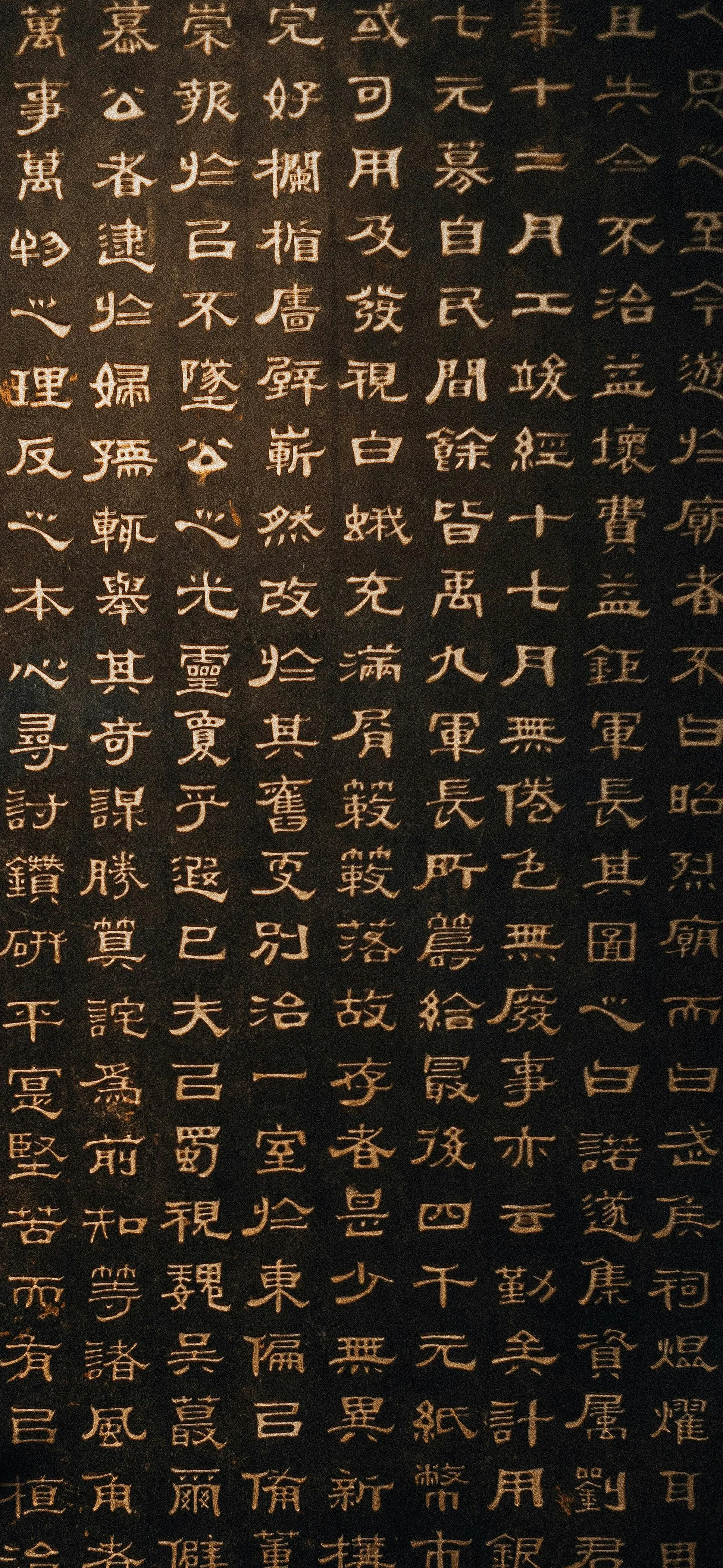Artistic Grid of Ancient Golden Symbols on Black Background