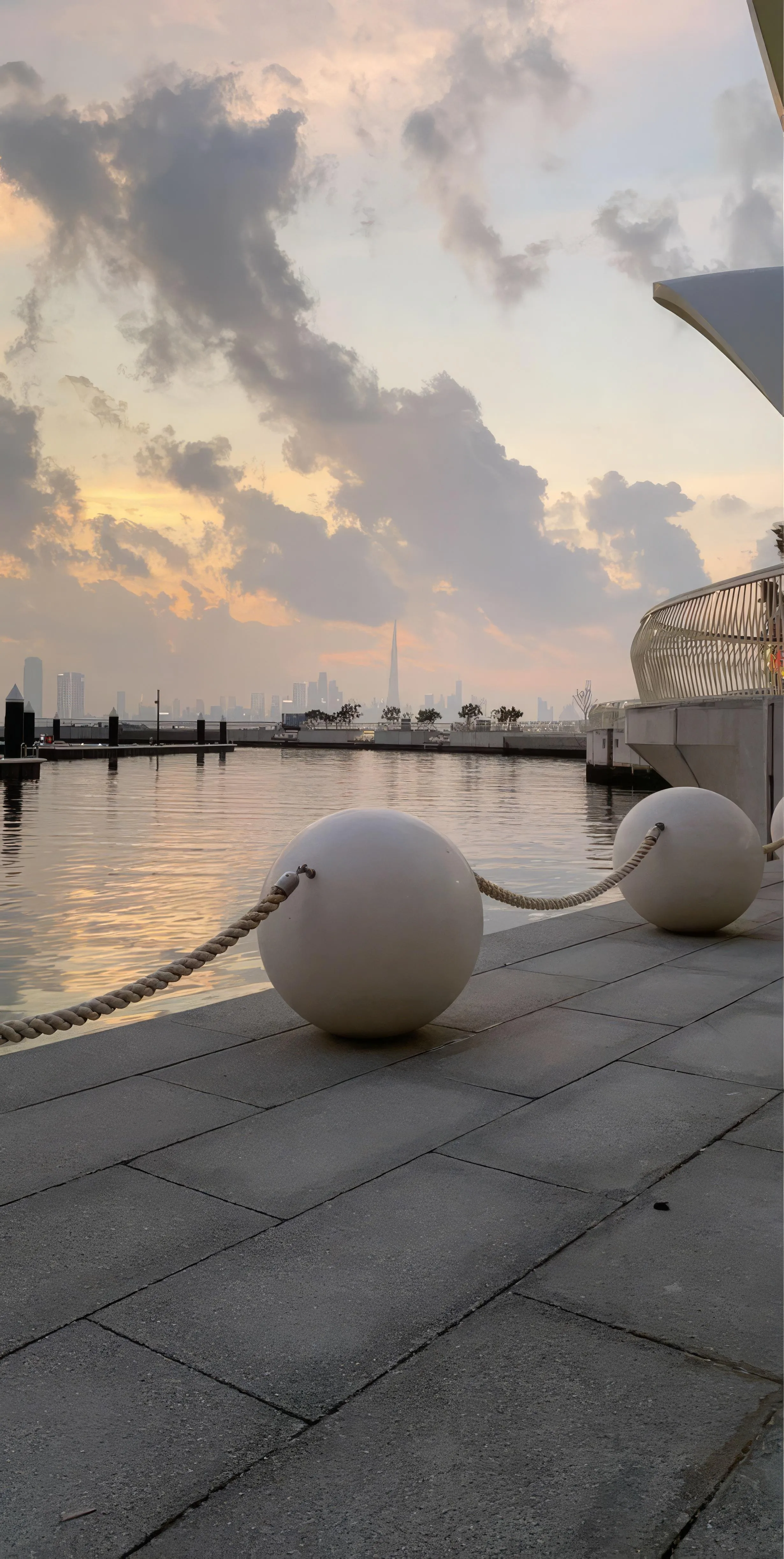 Artistic Seaside Promenade with Sculptures and Sunset