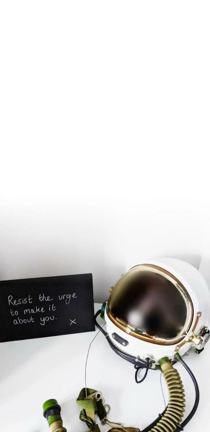Astronaut Helmet Beside Note Urging Thoughtful Humility