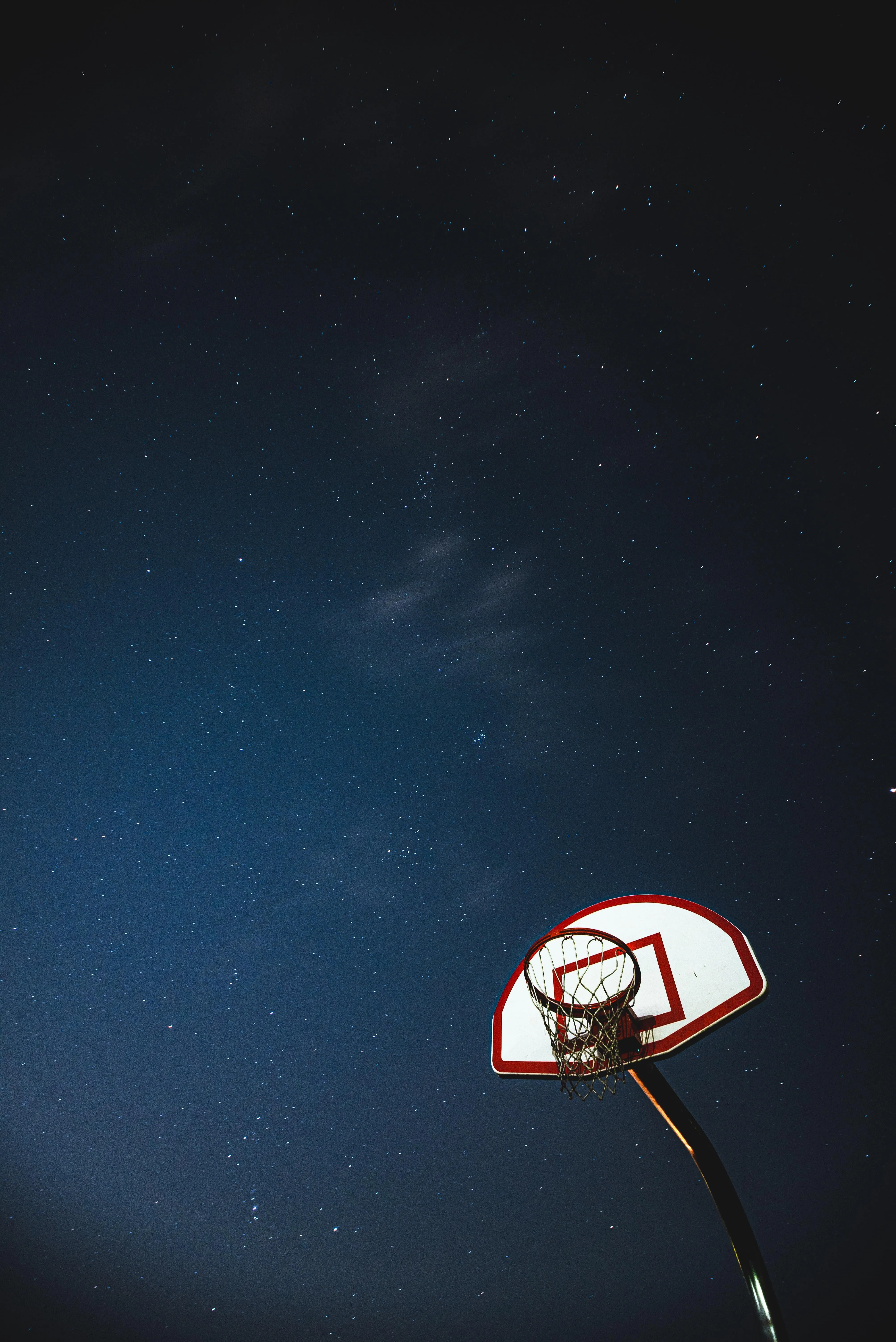 Basketball Hoop Silhouette Against Night Sky Wallpaper