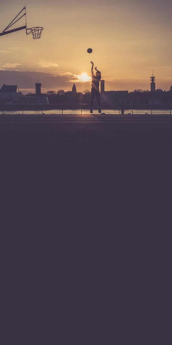 Basketball Player Shooting Ball at Sunset Court Wallpaper