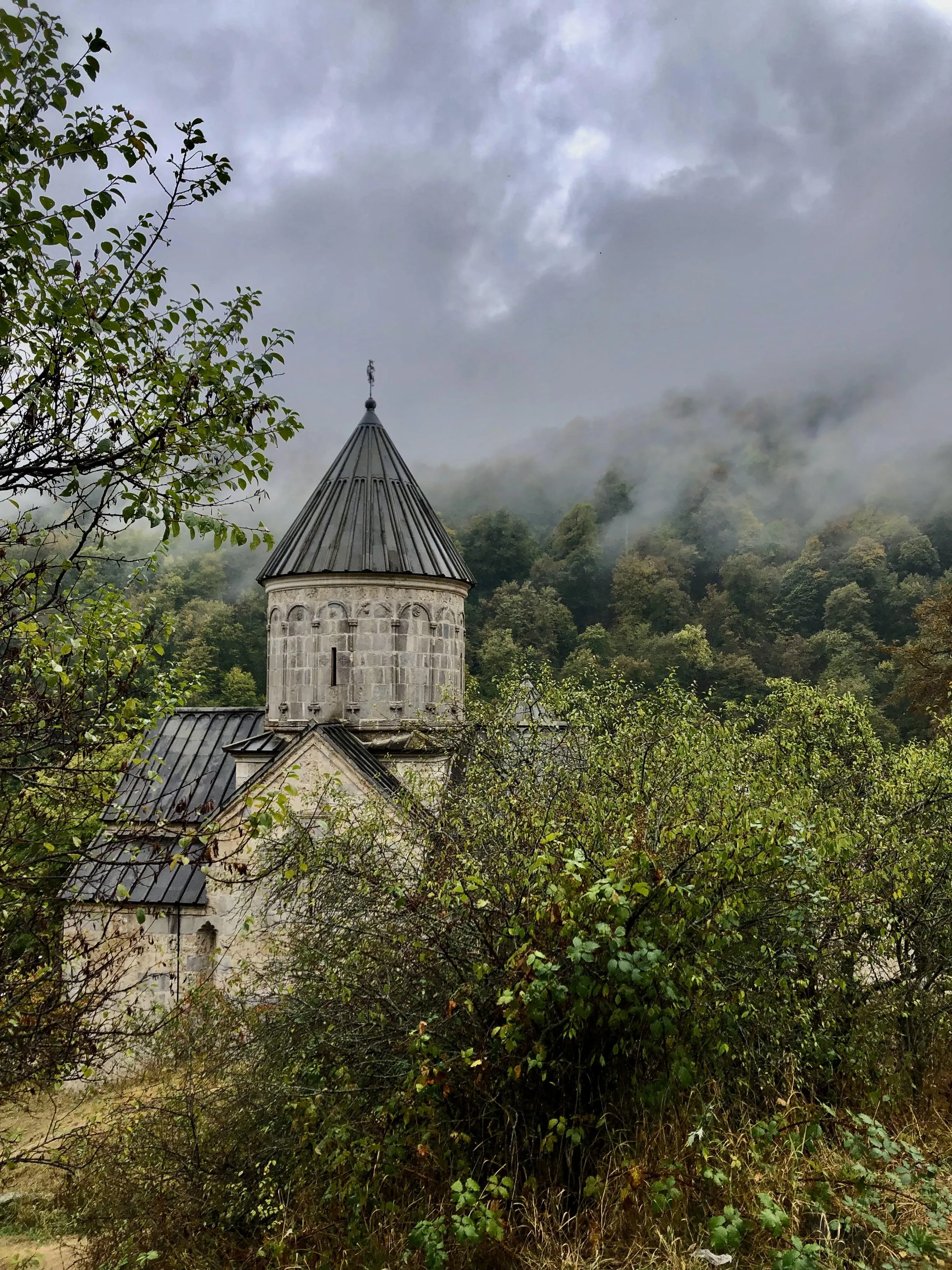 Beautiful Ancient Church Surrounded by Greenery and Fog
