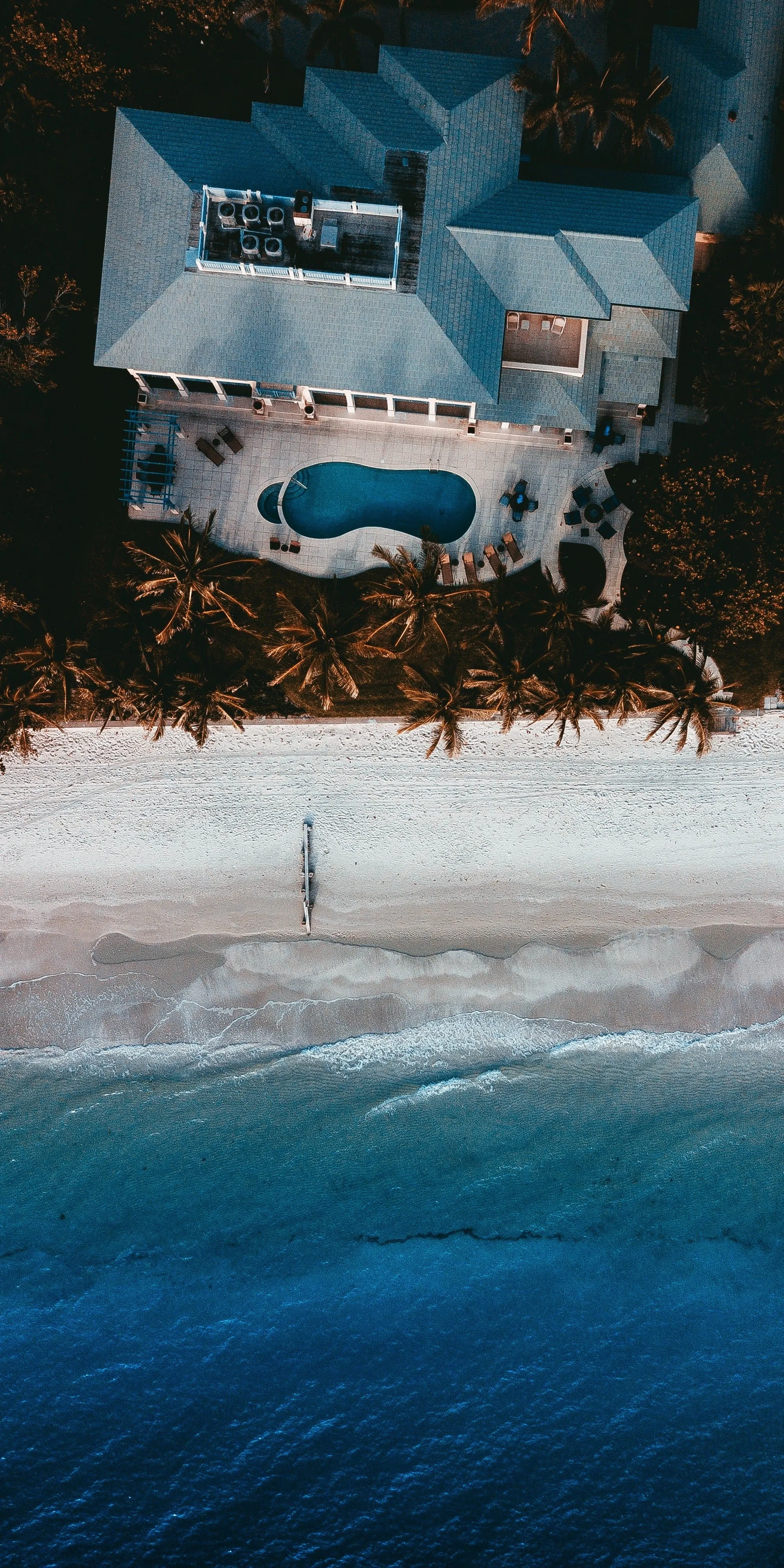 Beautiful Coastal Villa Surrounded by Blue Ocean Wallpaper