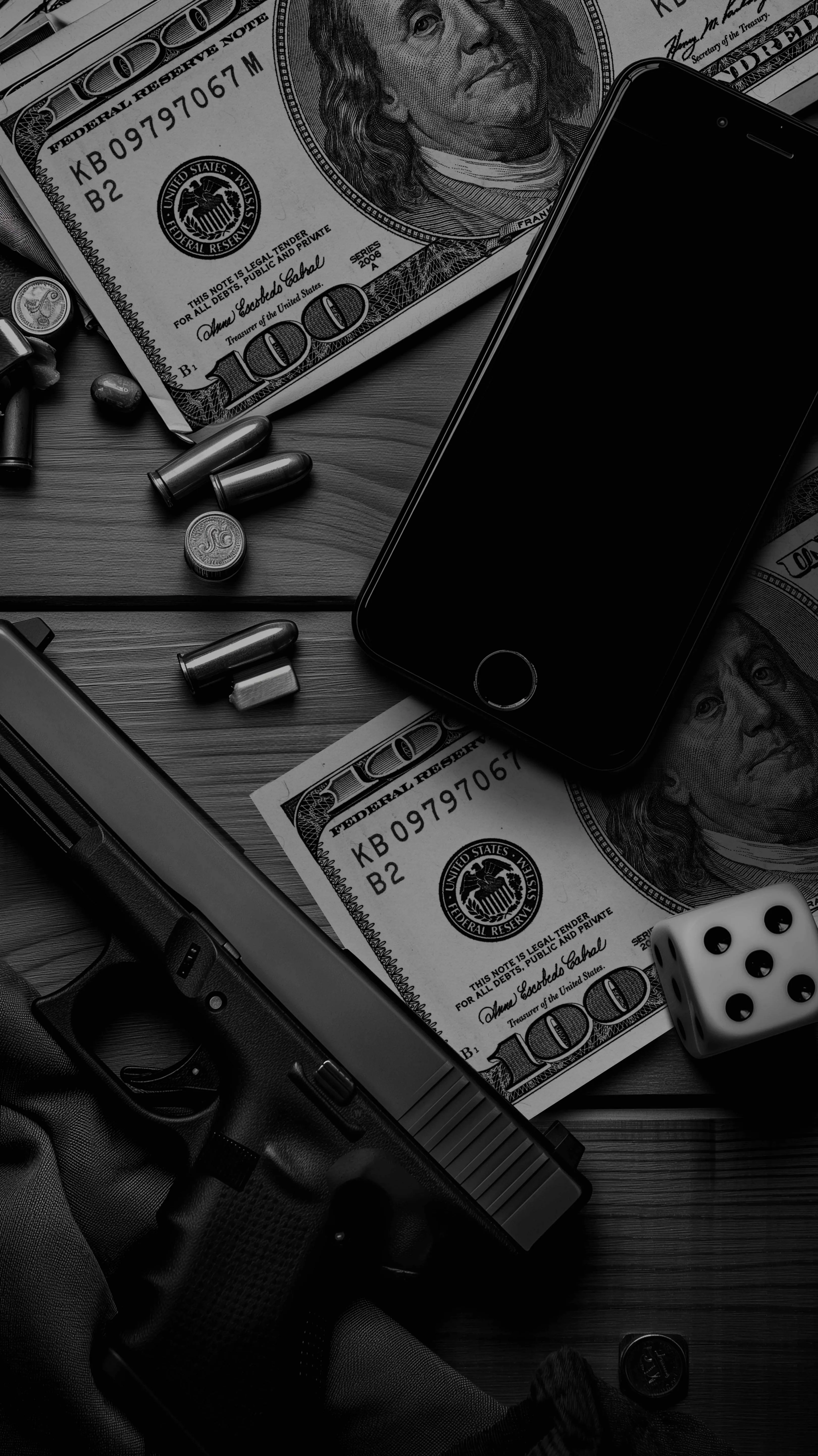 Black and White Image of a Table with Money Dice and Mobile