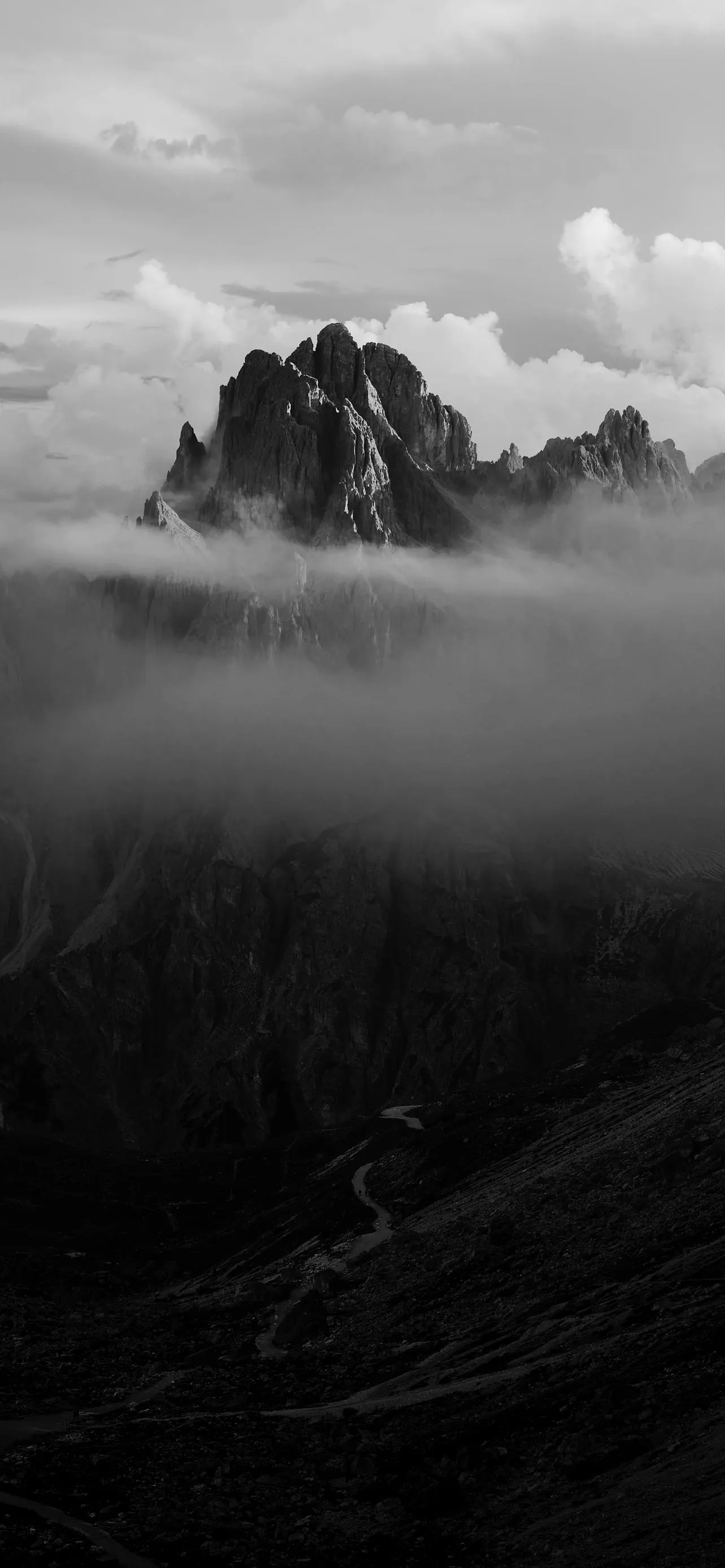 Black and White Mountains Covered in Moody Fog Wallpaper