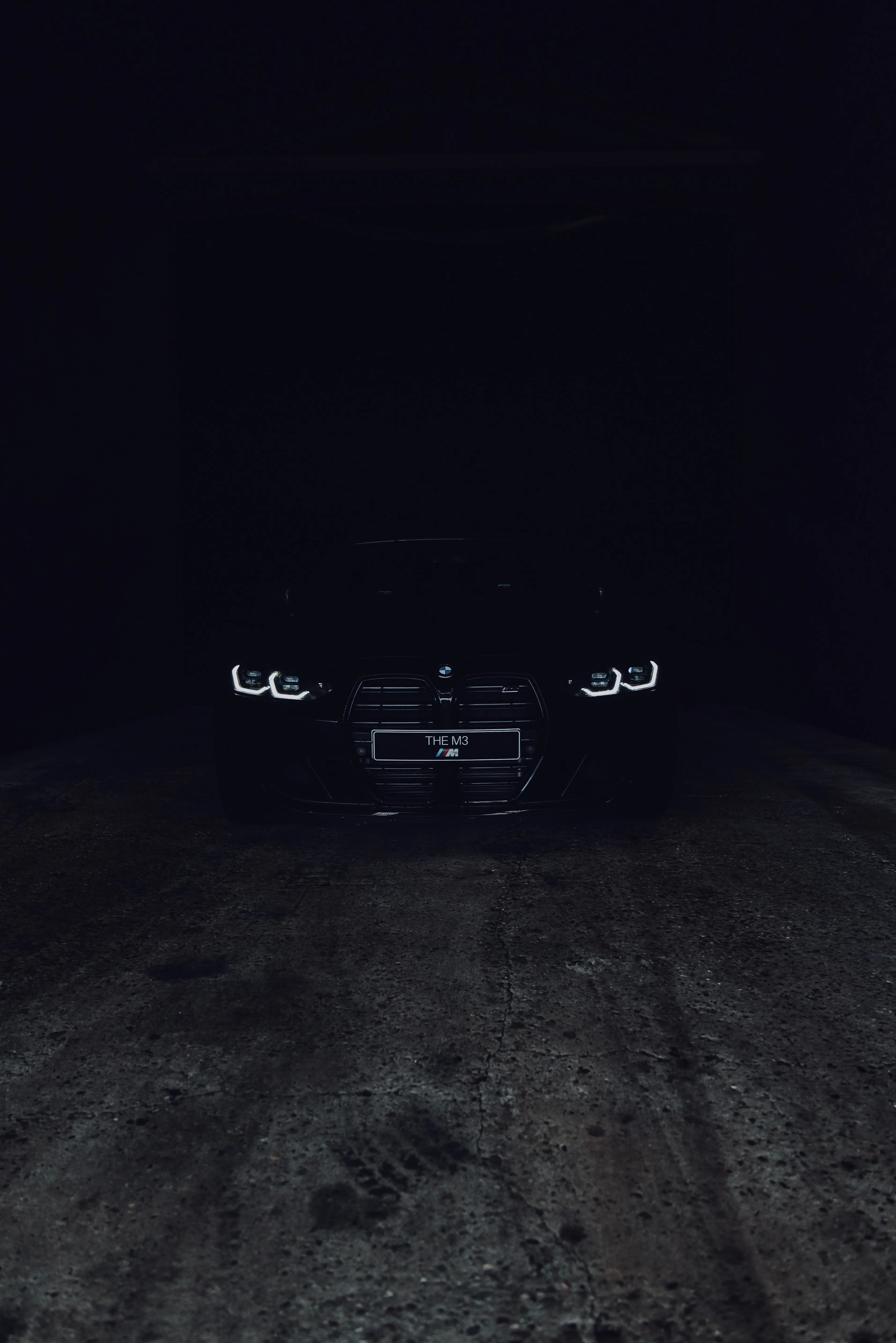 Black Car Headlights Glowing in Dark Night Road Wallpaper