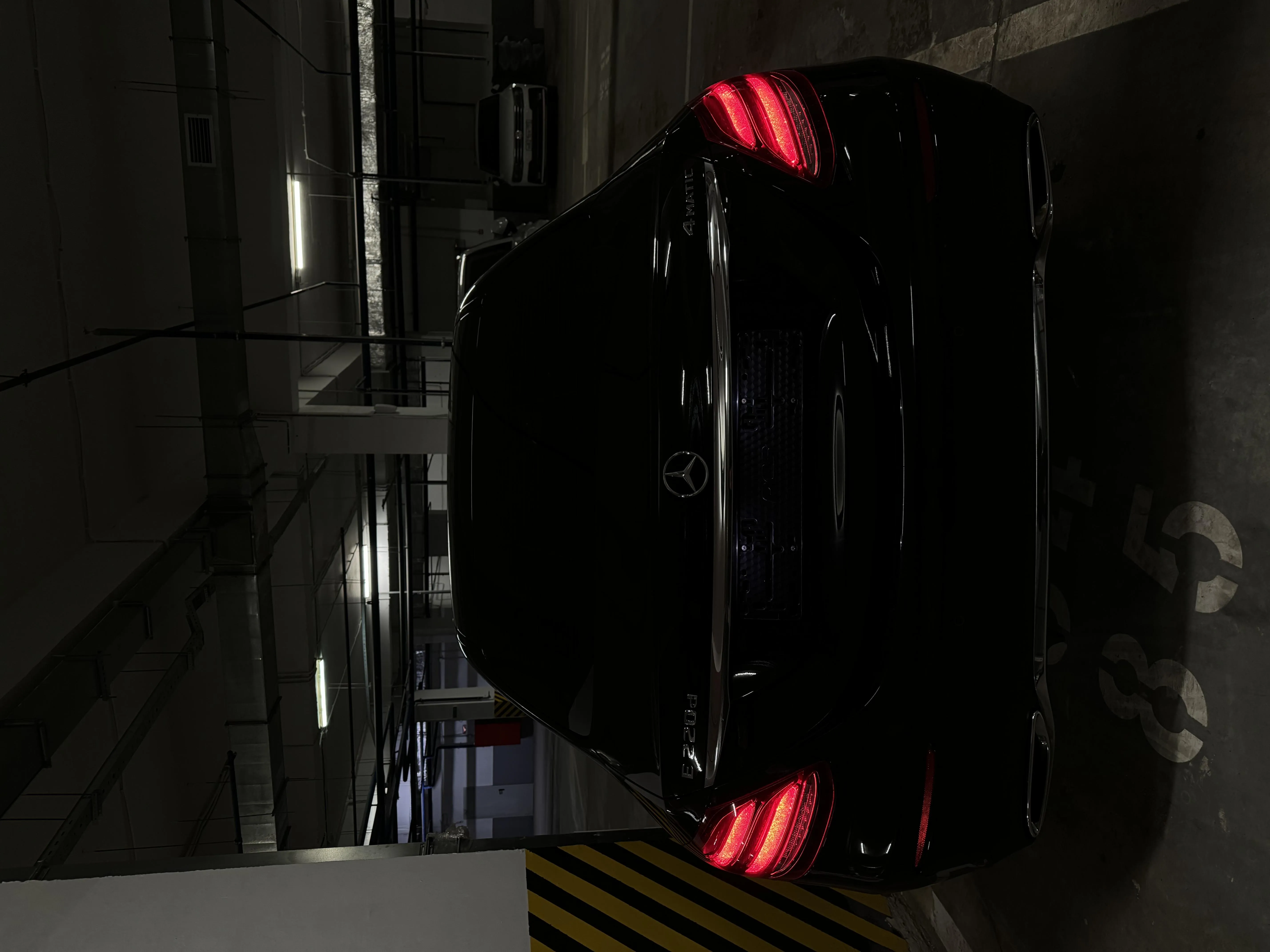 Black Car Parked in Dim Underground Garage Light Wallpaper