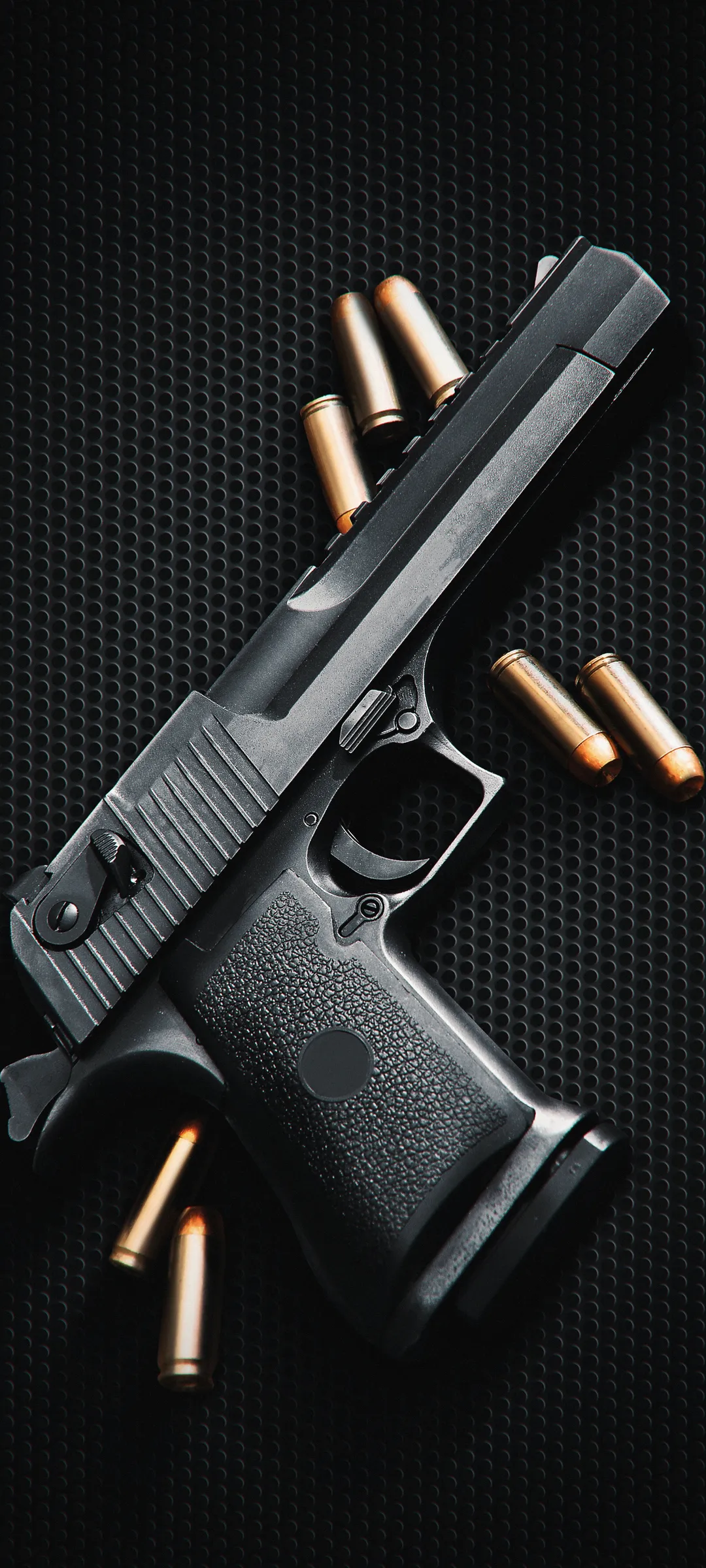 Black Handgun with Bullets on Dark Textured Background