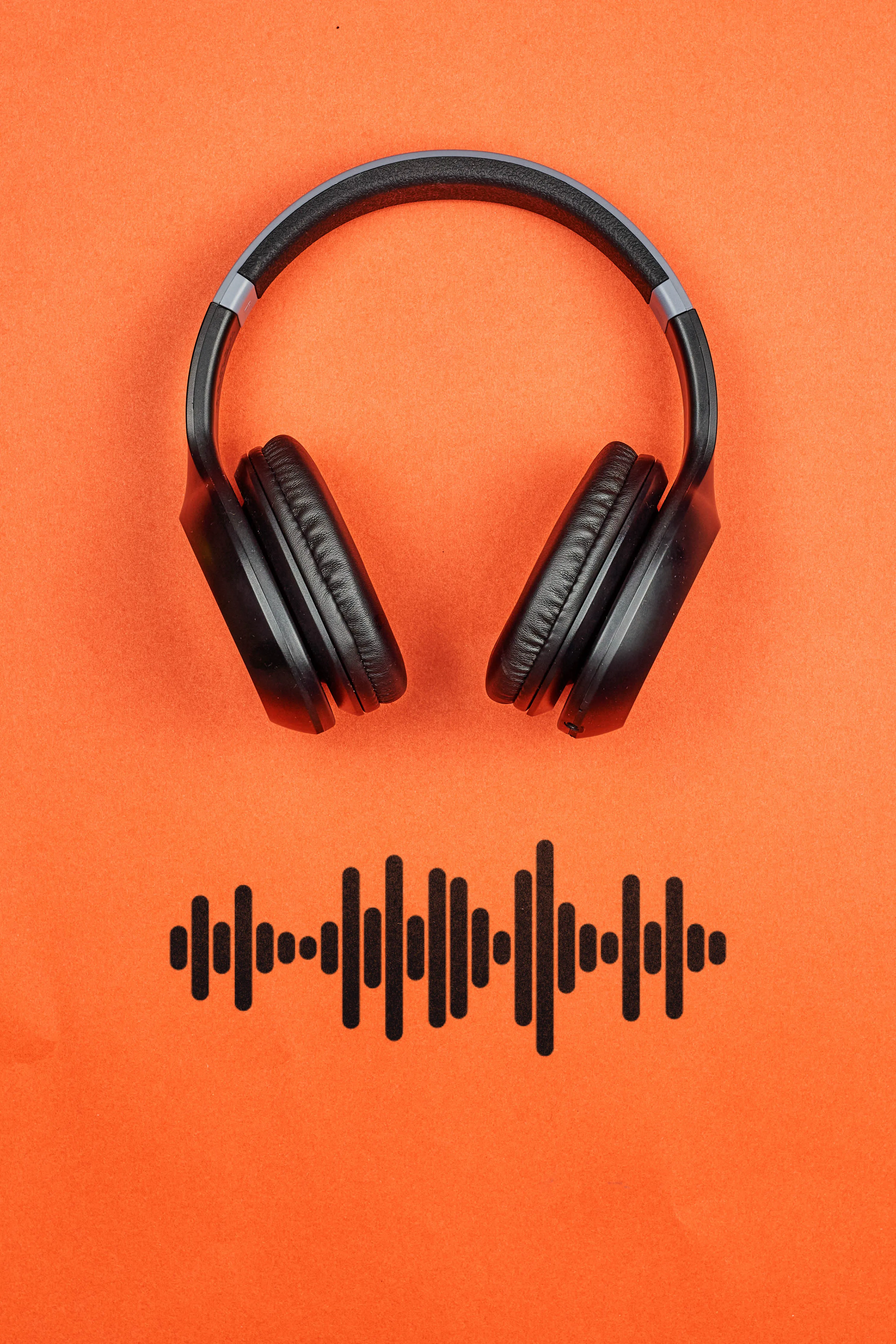 Black Headphones on Orange Background Design Wallpaper