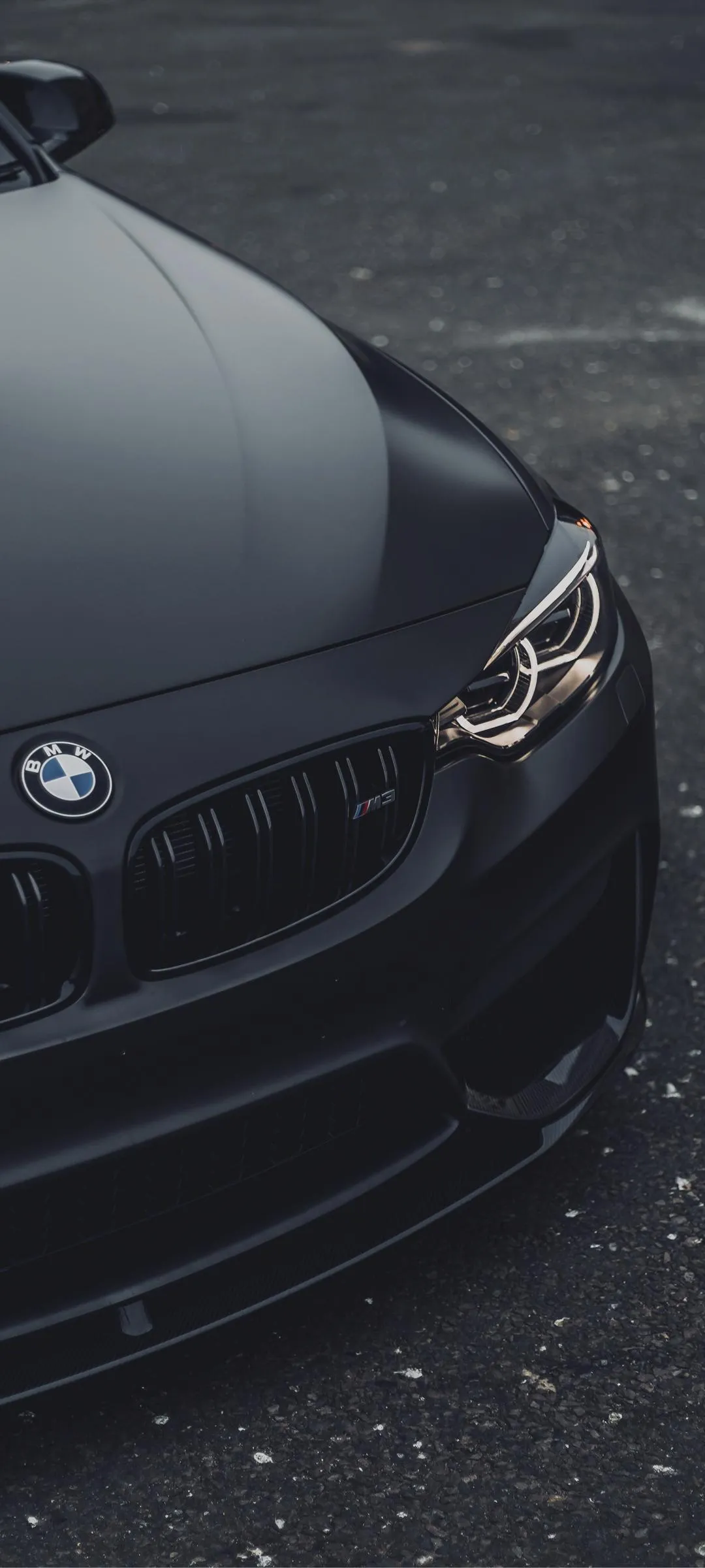 Black Luxury Car Front View in Modern Urban Setting