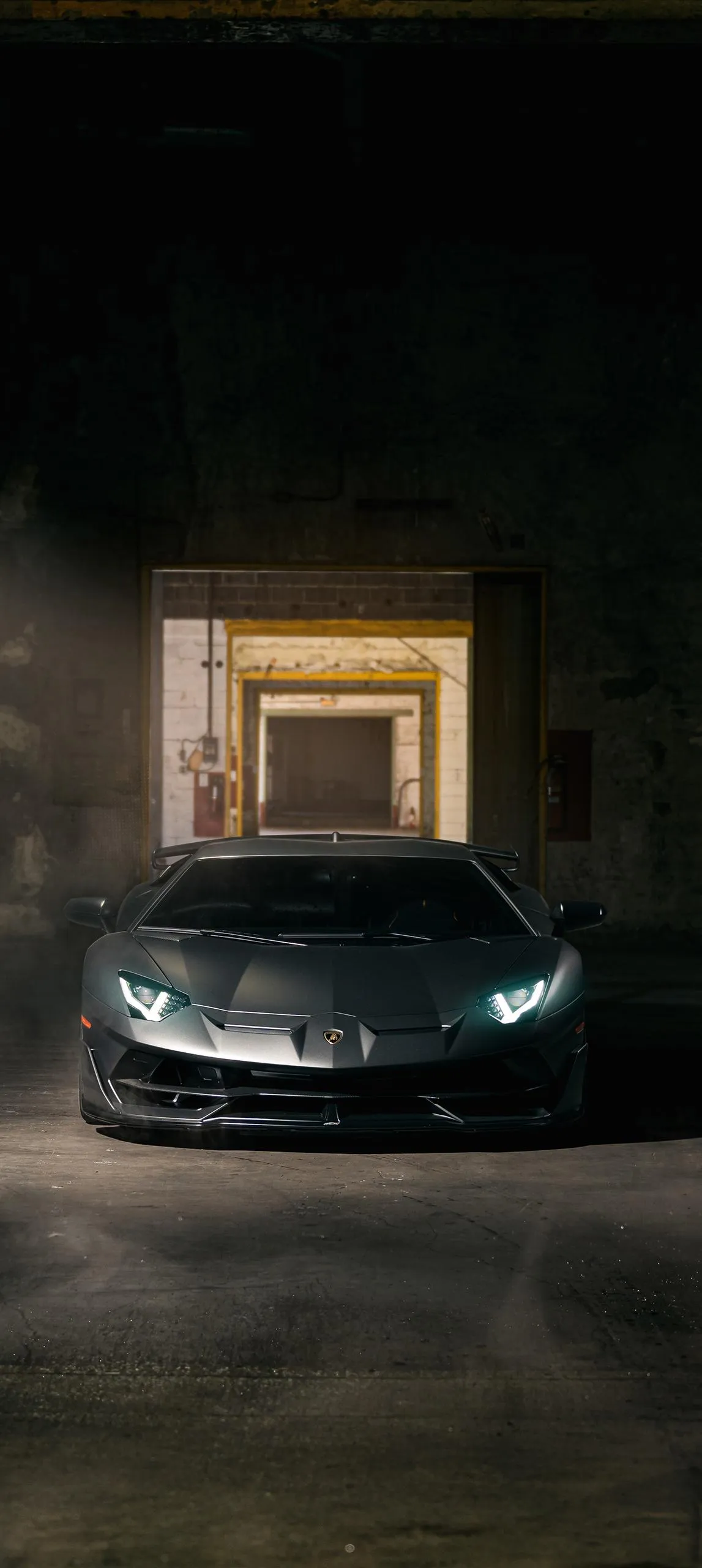 Black Luxury Car in Golden Light Tunnel Scene Wallpaper