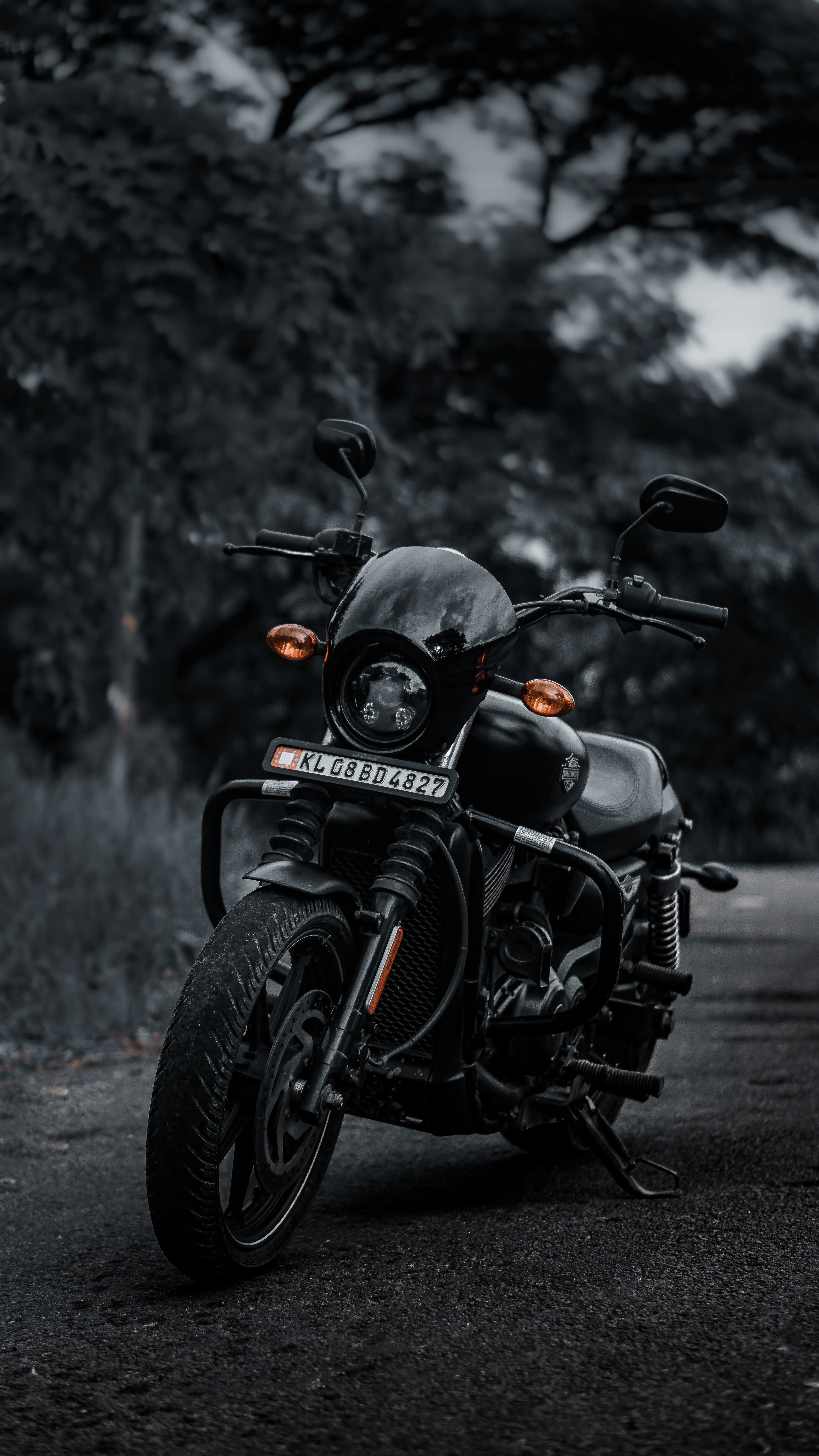 Black Motorcycle Parked on Road in Dark Forest Oppo Image