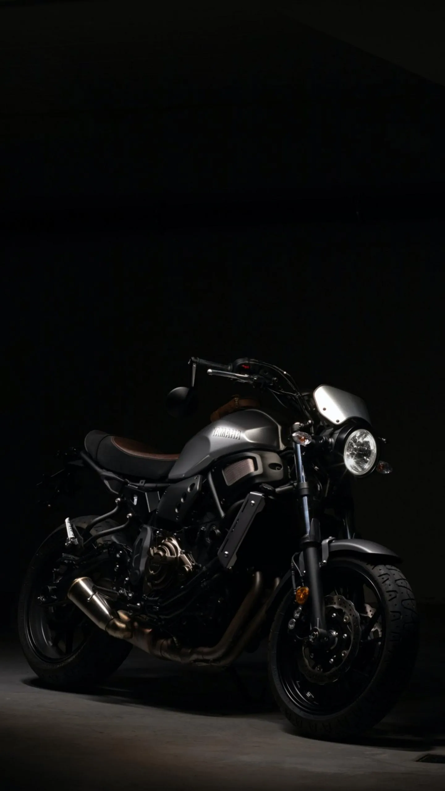 Black Motorcycle with Spotlight in Dark Studio Wallpaper