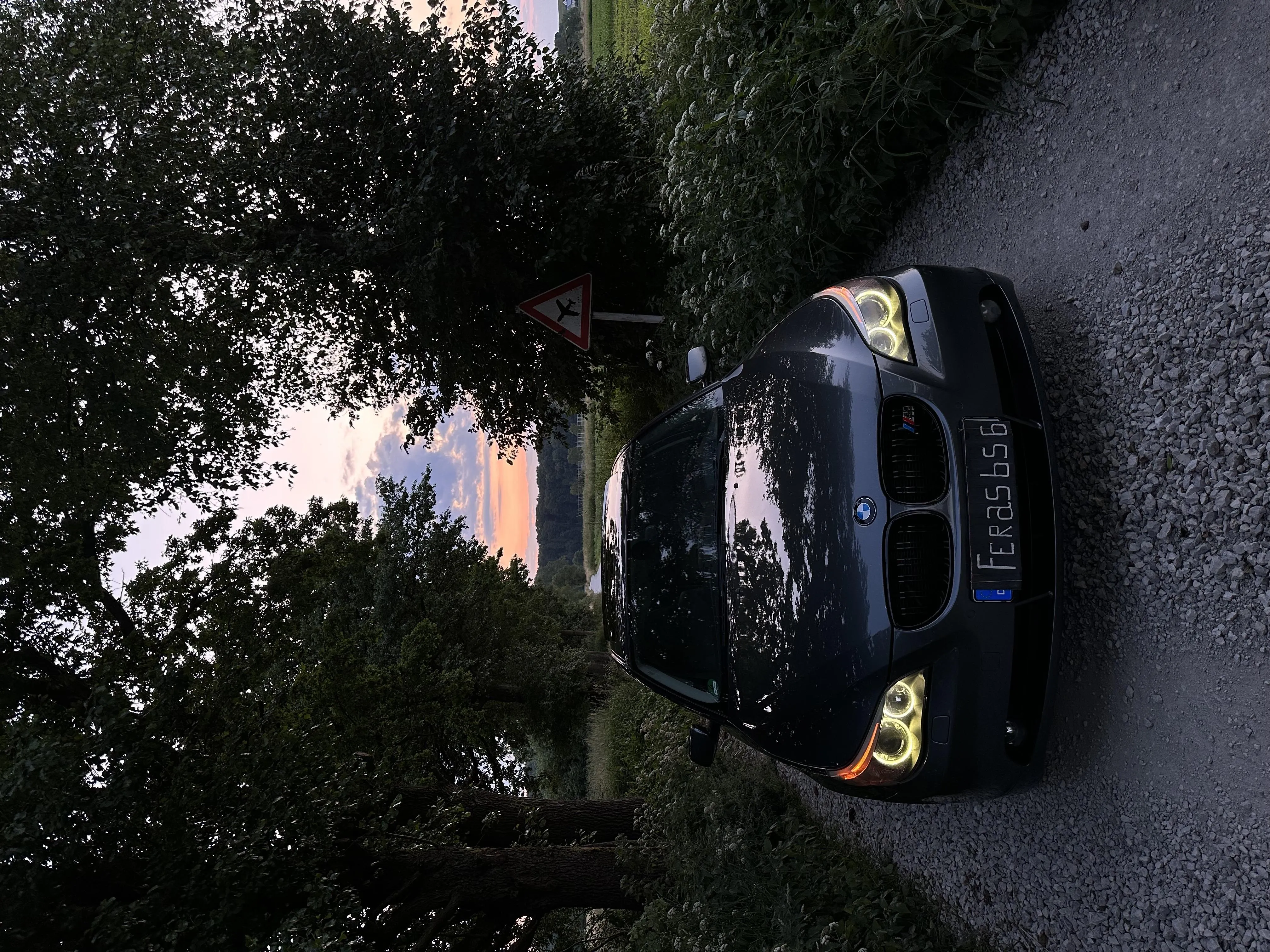Black Sports Car Parked Near Trees on Quiet Residential Road