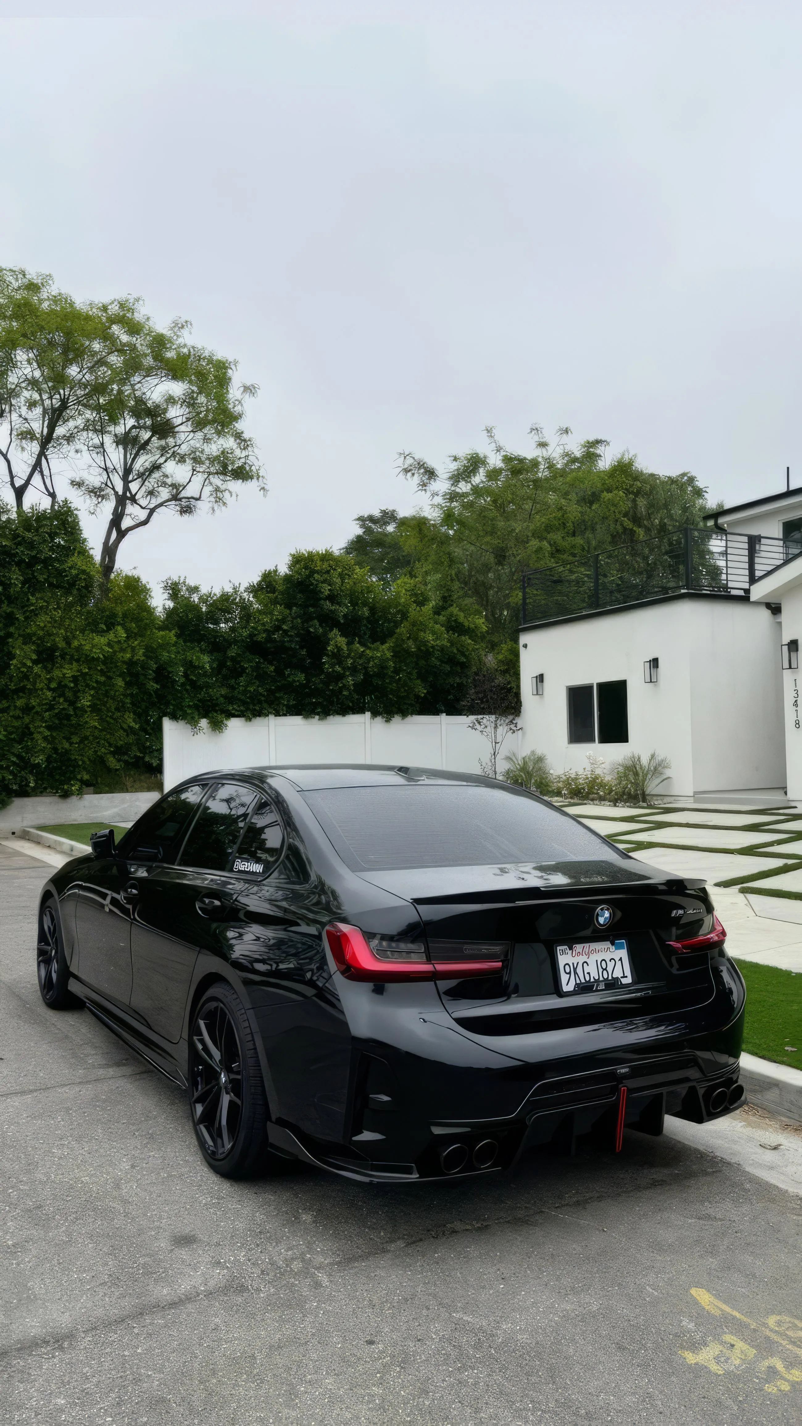 Black Sports Car Parked on Street in Urban Setting Wallpaper