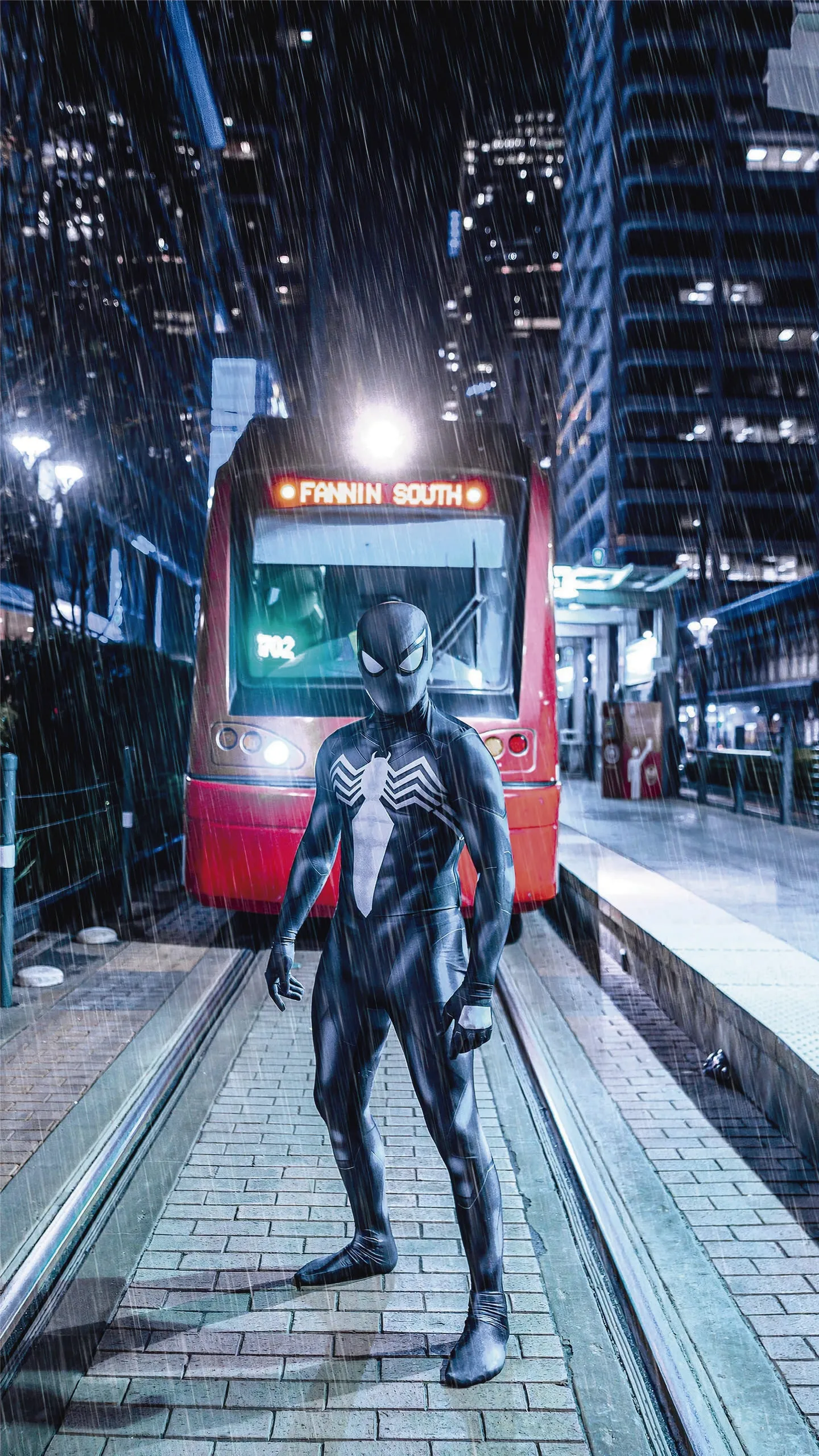 Black Suit Spider Hero Stands Strong in City Rain Wallpaper