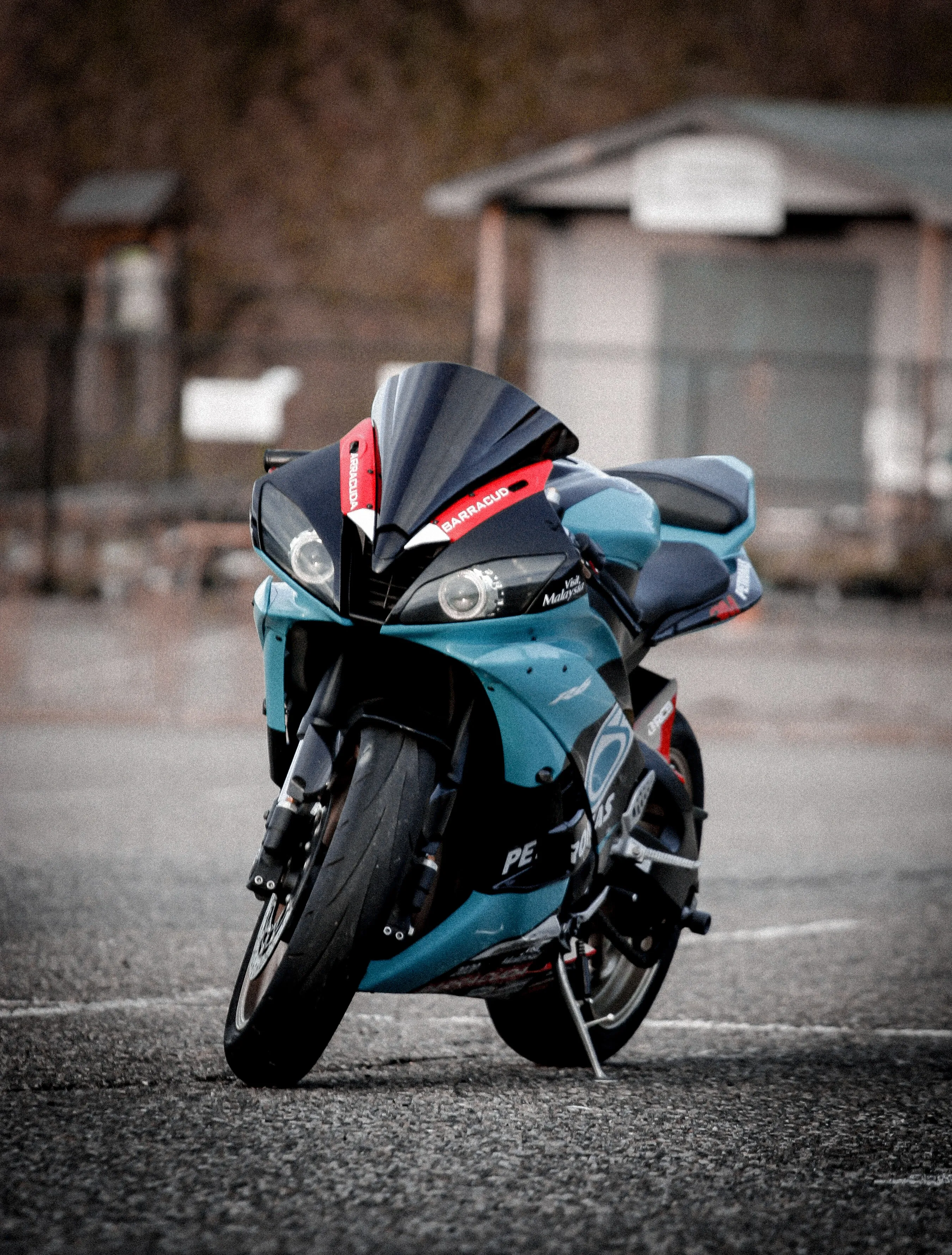 Blue Motorcycle Parked on Wet Road After Rain Wallpaper