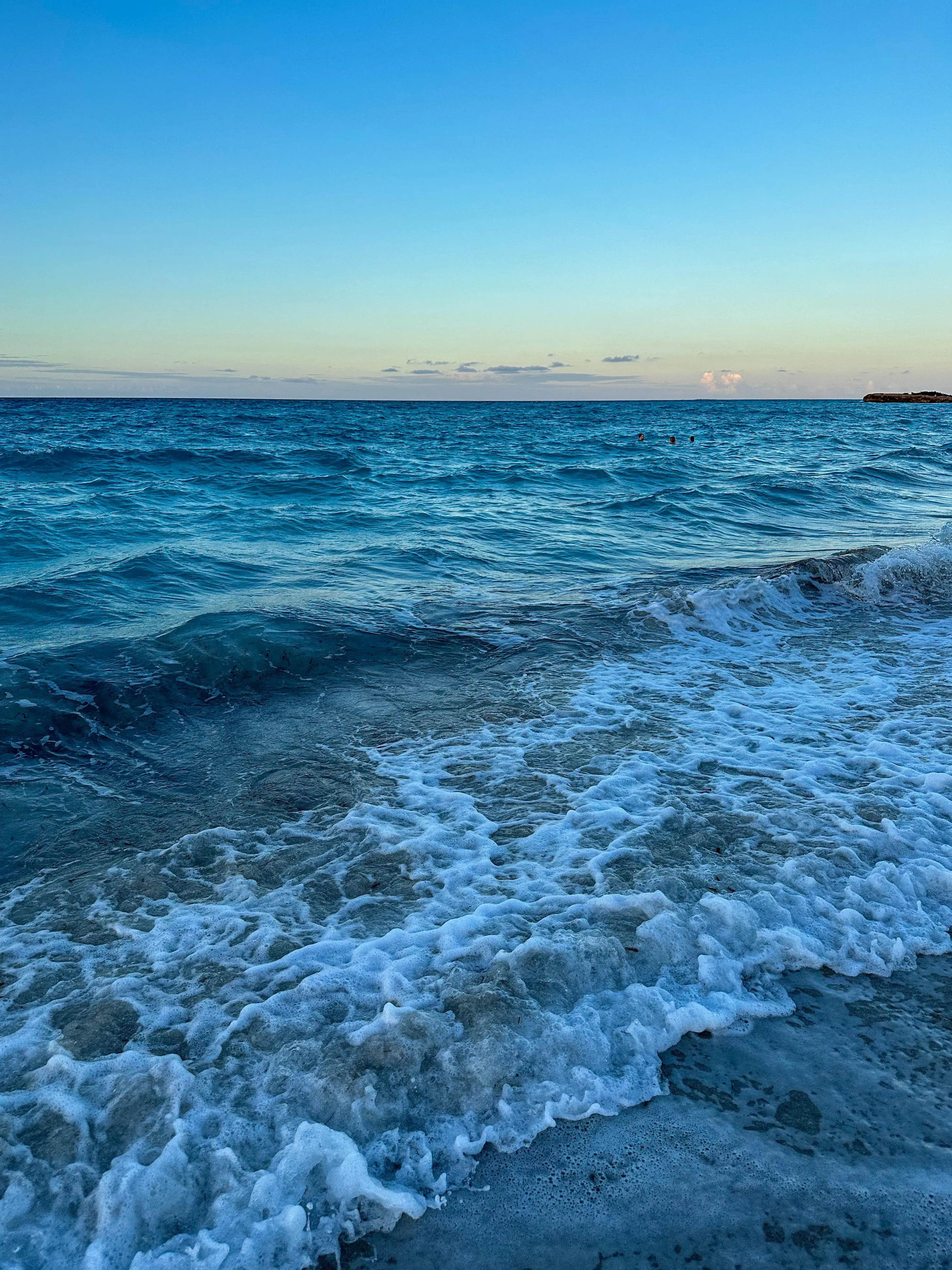 Blue Ocean Waves Crashing Under Clear Sky Wallpaper
