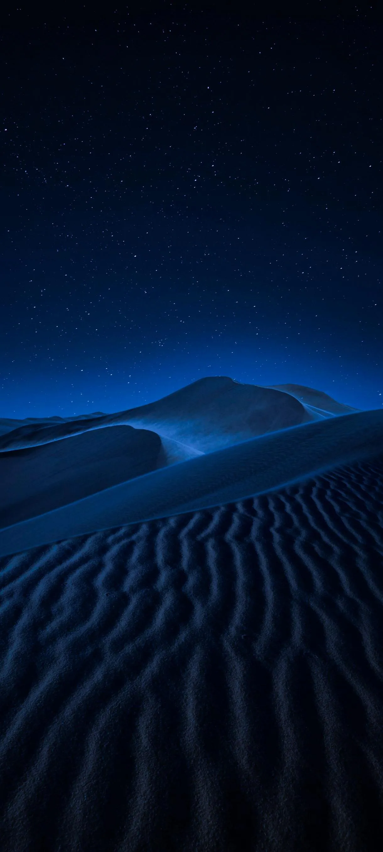 Blue Sand Dunes under Night Sky with Soft Lighting