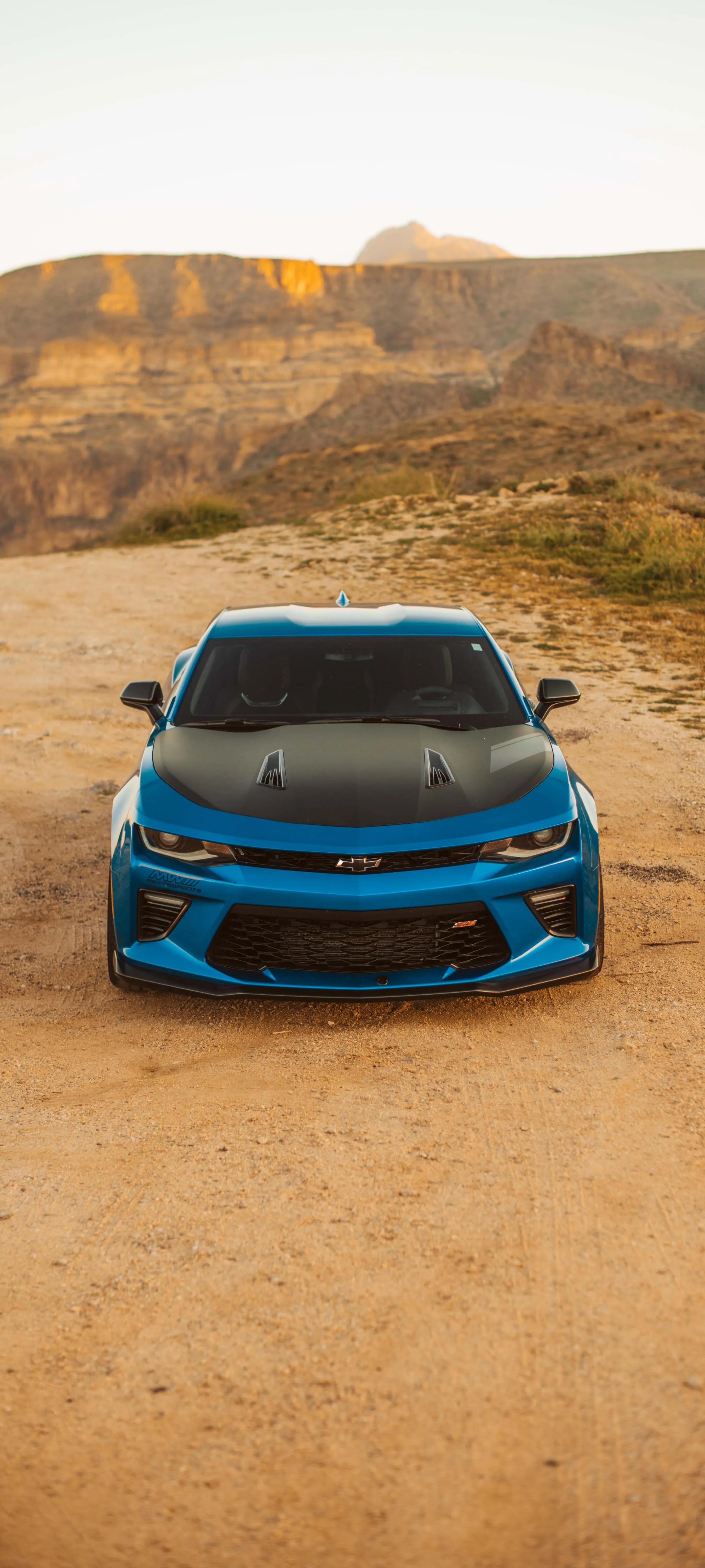 Blue Sports Car Parked on Desert Road in Daylight Wallpaper