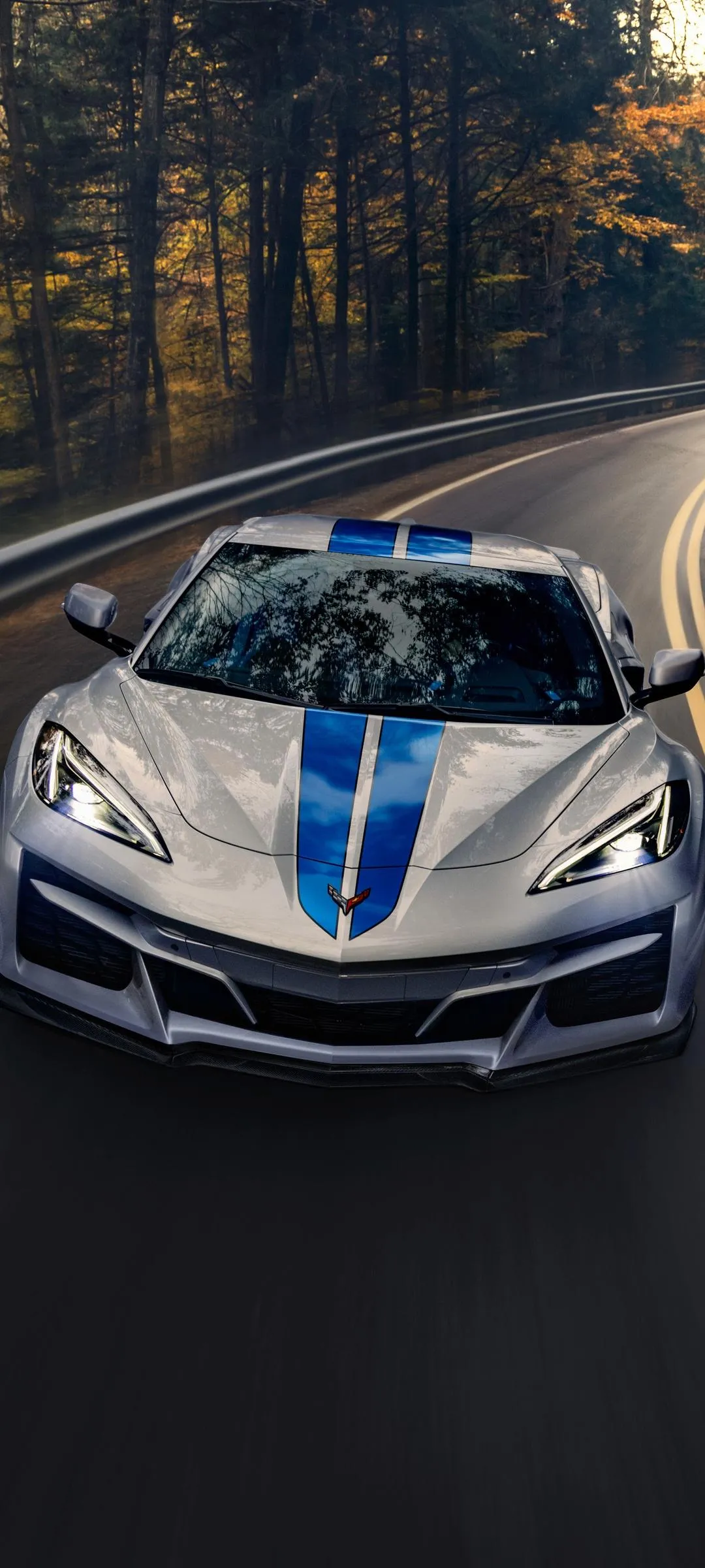 Blue Sports Car Racing on Wet Forest Highway Wallpaper