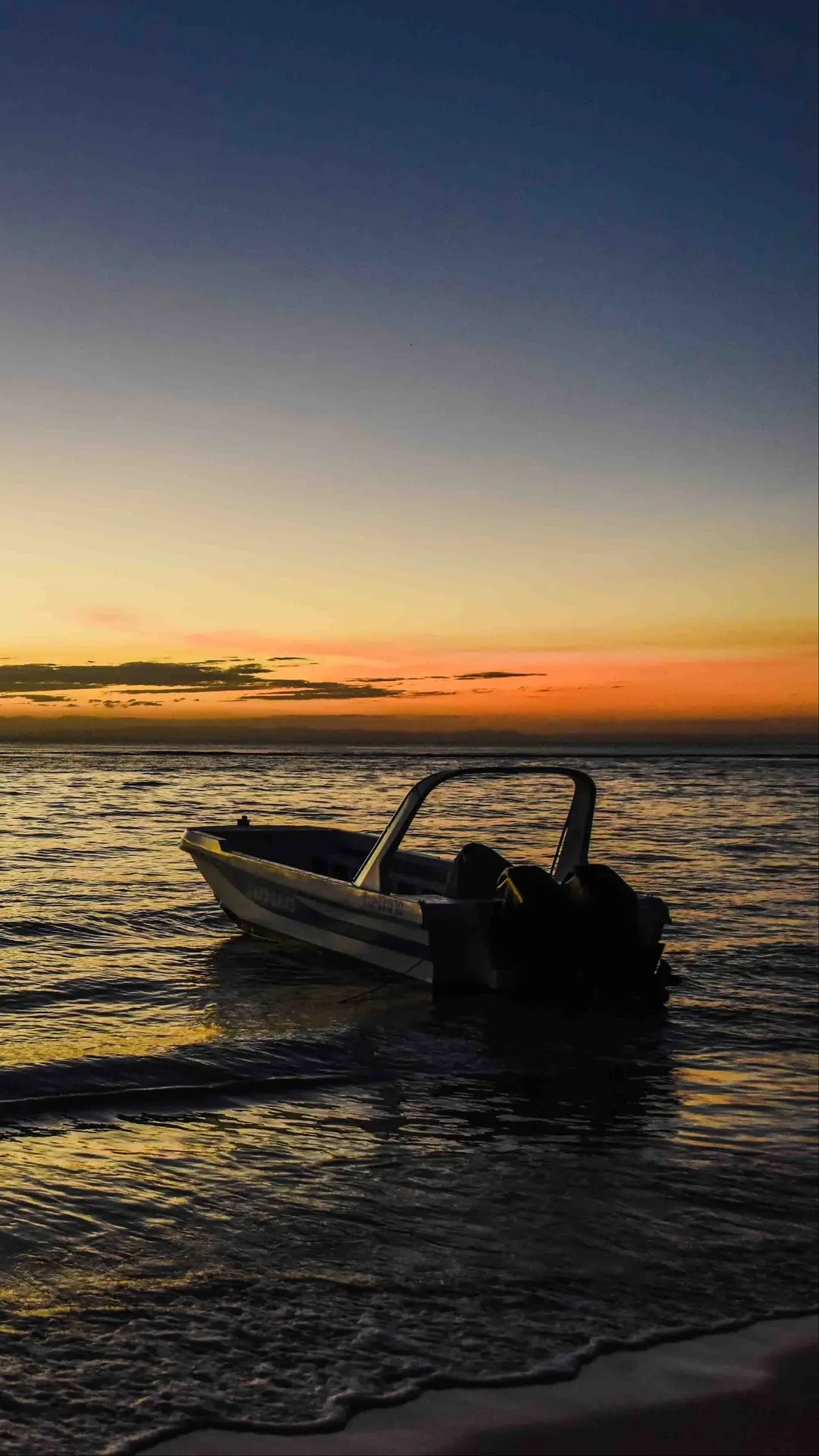Boat Floating Calmly on Water at Sunset Scene Wallpaper