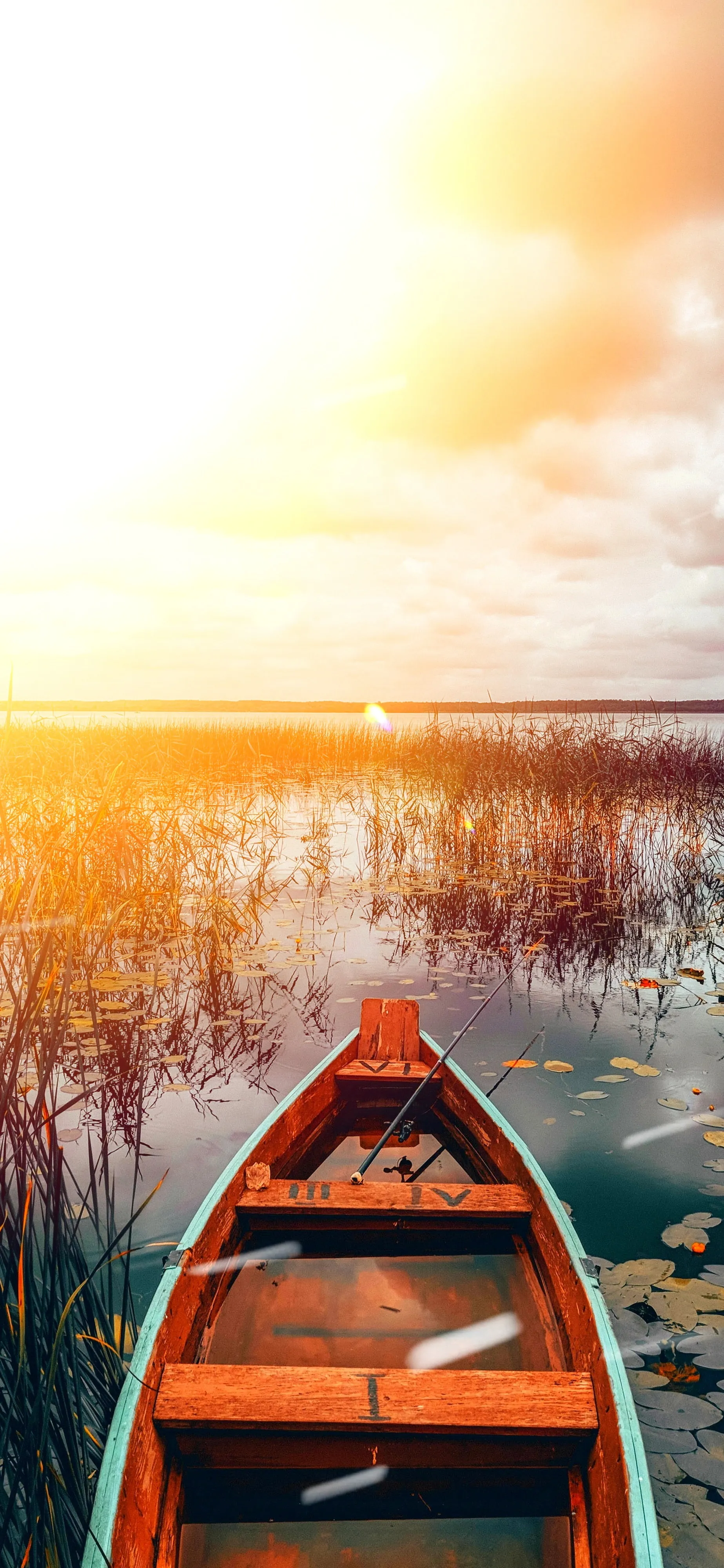 Boat on Water During Peaceful Golden Sunset Wallpaper