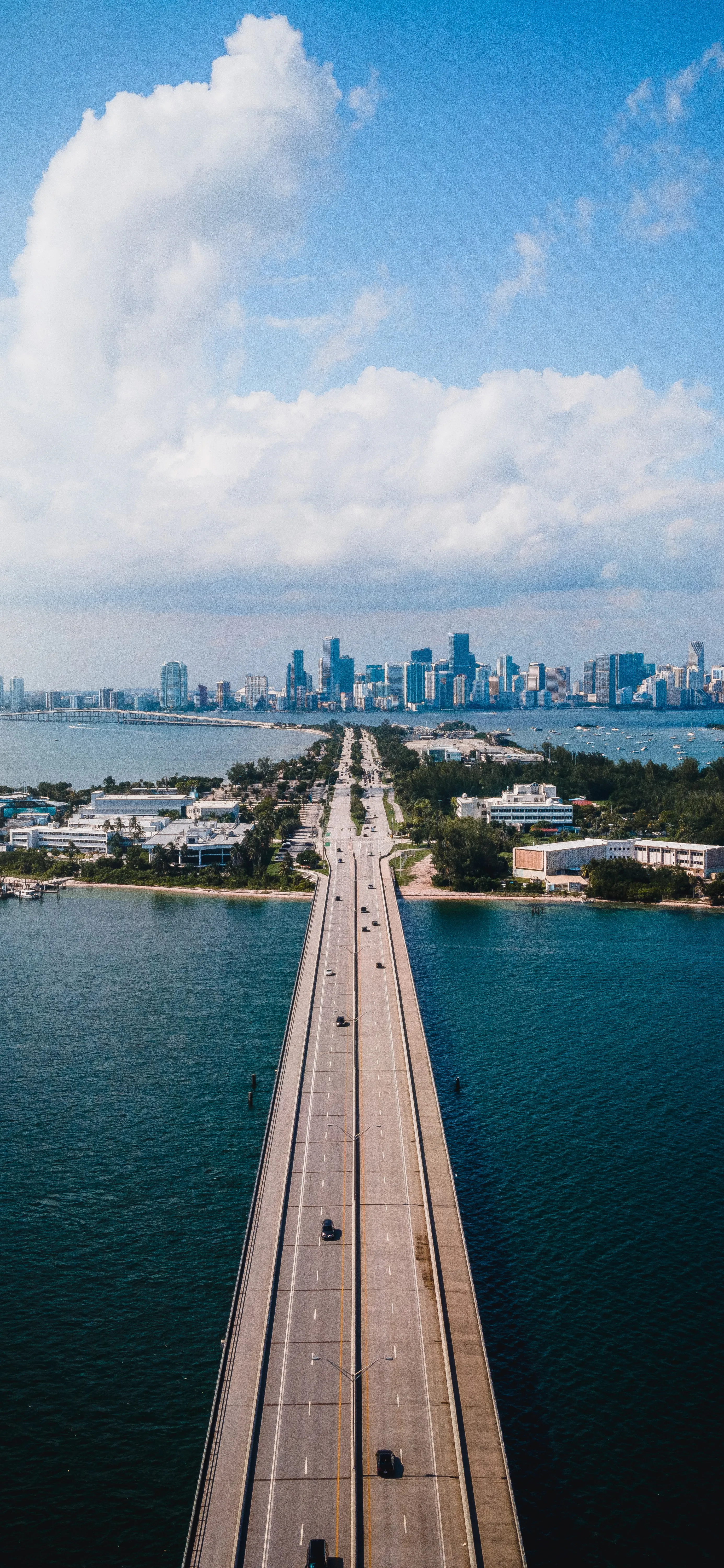 Bridge Leading To Modern City Skyline Blue Skies Wallpaper