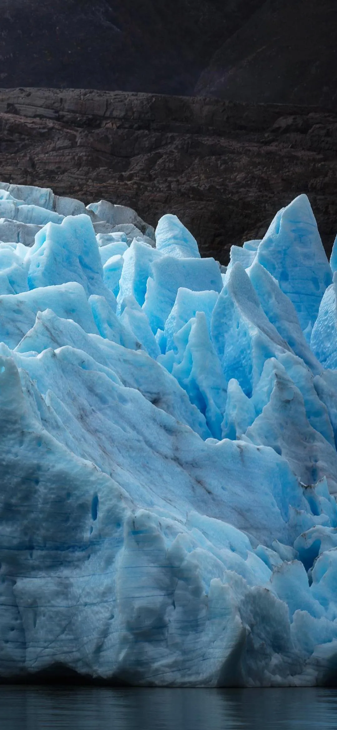 Bright Blue Ice Glacier with Rocky Landscape Wallpaper