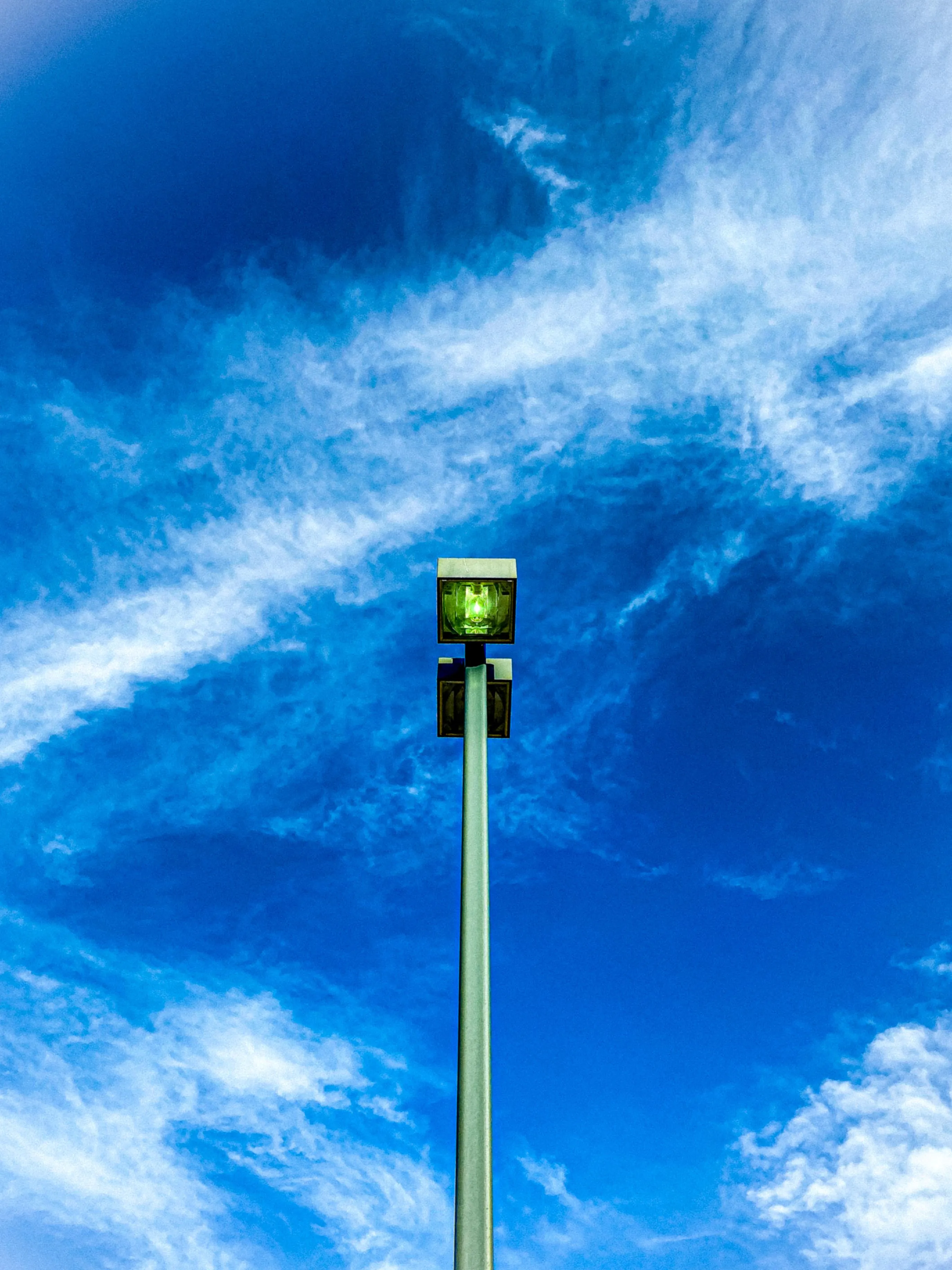 Bright Blue Sky with a Tall Signal Post in Open Space