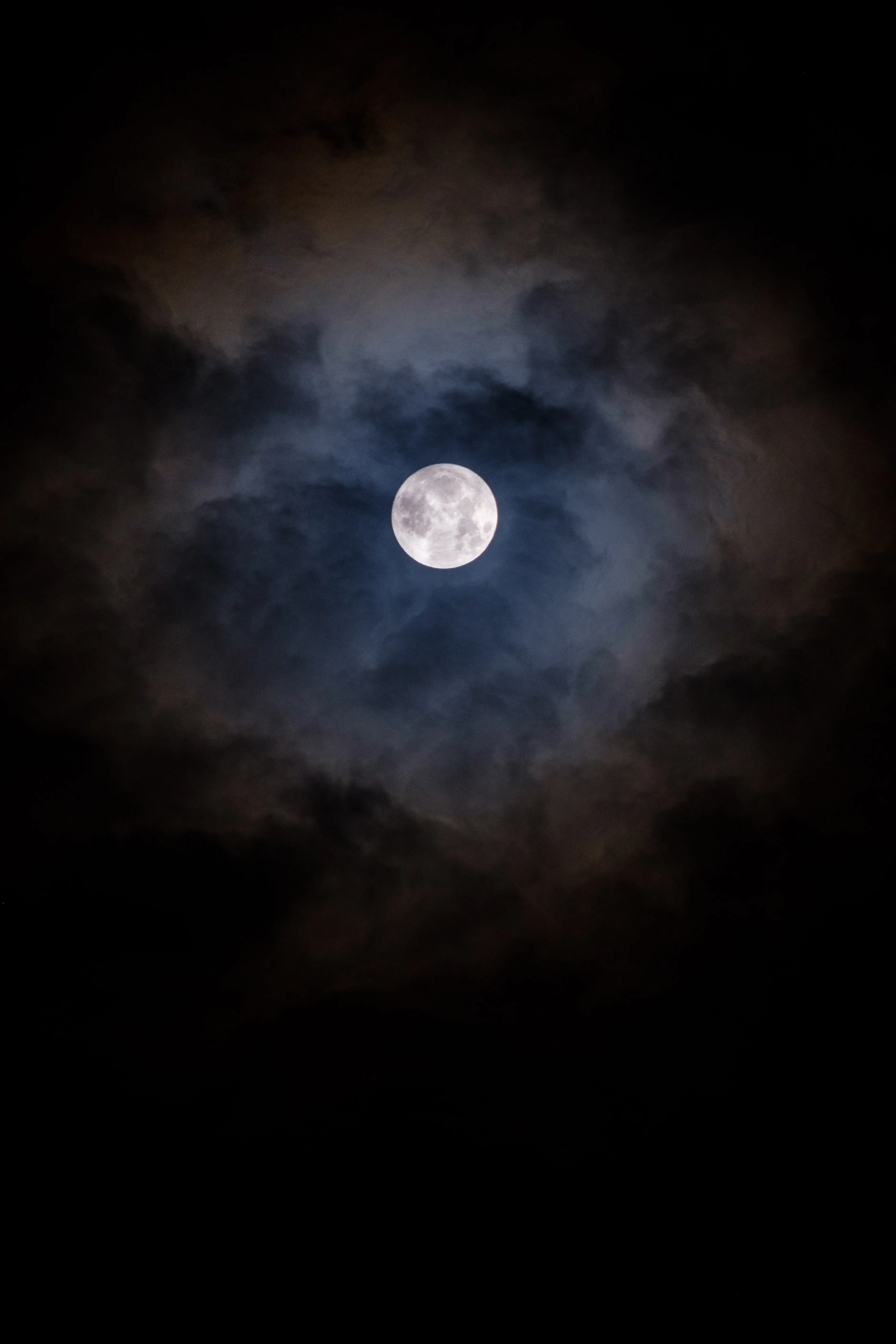 Bright Moon Surrounded by Dark Cloudy Sky Wallpaper