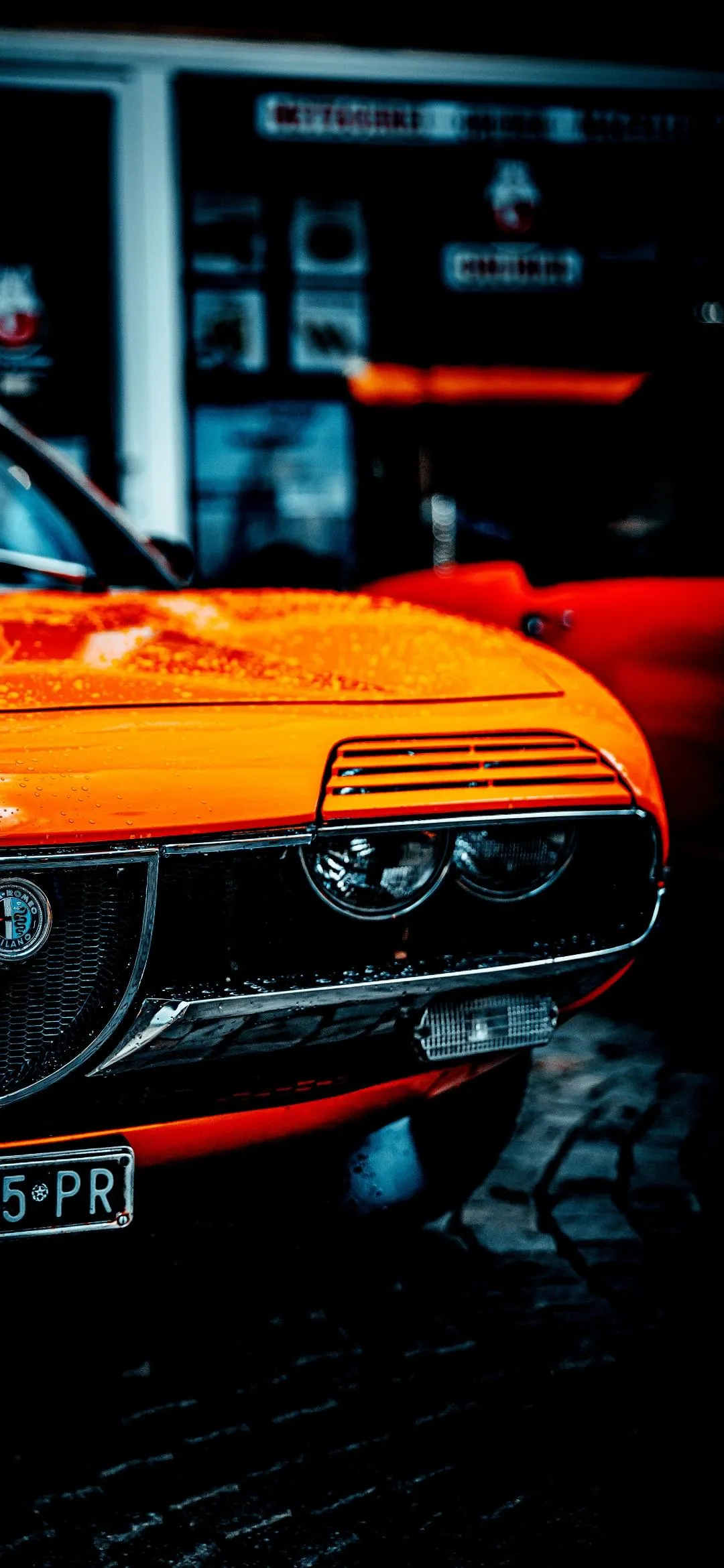 Bright Orange Sports Car Parked in Urban City Street