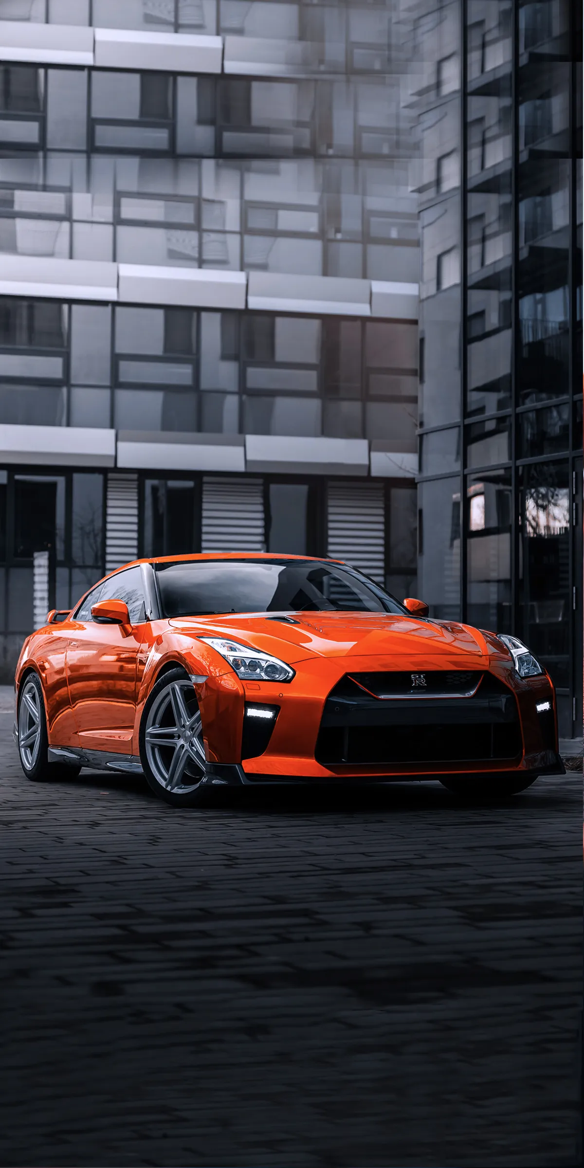 Bright Orange Sports Car Parked on a City Street Wallpaper